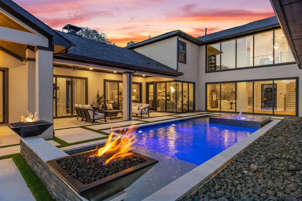WHY SETTLE FOR LESS WHEN YOU CAN HAVE A 2024 CUSTOM HOME WITH A POOL ON A HALF-ACRE ESTATE LOT—PLUS UNMATCHED AMENITIES IN PROSPER’S PREMIER MASTER-PLANNED COMMUNITY? Located in The Pinnacle, Windsong Ranch’s most exclusive enclave, 381 Spade Ranch by Partners in Building occupies one of only 40 half-acre estate lots. Set at the end of a cul-de-sac, the property sides to a mature greenbelt and captures unforgettable Texas sunsets—all within A-rated Prosper ISD.Inspired by the builder’s model, the design was elevated with a primary-suite fireplace and sliders to a covered patio, a glass-enclosed wine room with beverage fridge, and an expanded upstairs media room. A soaring two-story foyer and walls of windows fill the home with natural light, highlighting clean lines and sophisticated soft contemporary architecture.Outdoor living centers around a geometric pool with spillover spa, tanning ledge, water wall, and fire bowls. Multiple covered patios, an outdoor kitchen, firepit, and spacious lawn offer entertaining space, plus room for a sport court and putting green.The kitchen features an oversized island with refrigerated drawers, double ovens, warming drawer, 6-burner gas range with griddle, pot filler, and custom cabinetry. A first-floor entertainment room with pool bath opens through 9-foot sliding glass doors to the outdoor kitchen for seamless indoor-outdoor living.The downstairs primary suite offers a fireplace, patio access, and a dramatic bath with two-story ceilings, soaking tub, walk-through shower with dual showerheads, and separate vanities. A home office with built-ins and guest suite are also downstairs. Upstairs are two additional ensuite bedrooms and the expanded media room with half bath.Additional features include central vacuum, two walk-in attics, and an oversized 3-car garage with golf-cart parking and storage. Windsong Ranch amenities include a 5-acre lagoon, pools, trails, sports courts, and fitness center.