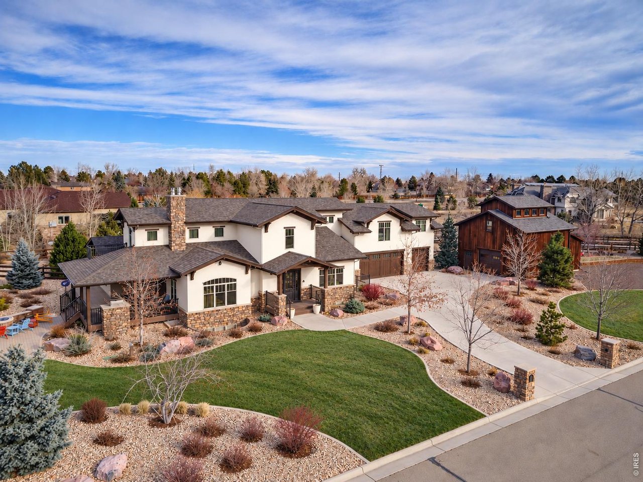 The High Point at Copper Hill. Set on 1.85 acres in Copper Hill, The High Point at Copper Hill commands a corner cul-de-sac setting with snowcapped Back Range and foothill views as its backdrop. Trails begin just steps from the door, while Louisville and Boulder are both within easy reach-an exceptional combination of space, scenery and connection. Designed to bring people together, the main level unfolds beneath vaulted ceilings with porcelain tile floors and an open, flowing layout made for effortless entertaining. The fully renovated main level flows from the kitchen to the dining and family rooms and straight out to the covered deck, so a gathering moves easily from indoors to out. The kitchen offers a BlueStar 8-burner range with griddle and pot filler, Sub-Zero refrigeration, Miele built-in coffee system, Scotsman ice maker, Cambria quartz, an island and a walk-in pantry. The family room adds big windows framing the view, a new, eye-catching gas fireplace and a sitting bar with beverage fridge. The lower level takes entertaining to another scale. A dramatic 50-foot recreation room creates space for everything from game nights to large celebrations, joined by a media room, wet bar and indoor endless pool. A private study adds versatility beyond the home's extensive gathering spaces. Outside, the experience continues across the expansive grounds. Host a tournament on the private volleyball court, practice on the putting green, gather on the deck and patio. The acreage creates a rare sense of openness, with multiple spaces designed for recreation, entertaining and enjoying Colorado outdoors. An attached three-car heated garage is complemented by a barn with a fourth tandem space, providing substantial room for vehicles, gear and projects. With expansive indoor and outdoor entertaining spaces, remarkable mountain views and trails just beyond the property, the High Point at Copper Hill is a home built to gather, play and celebrate on a grand scale.