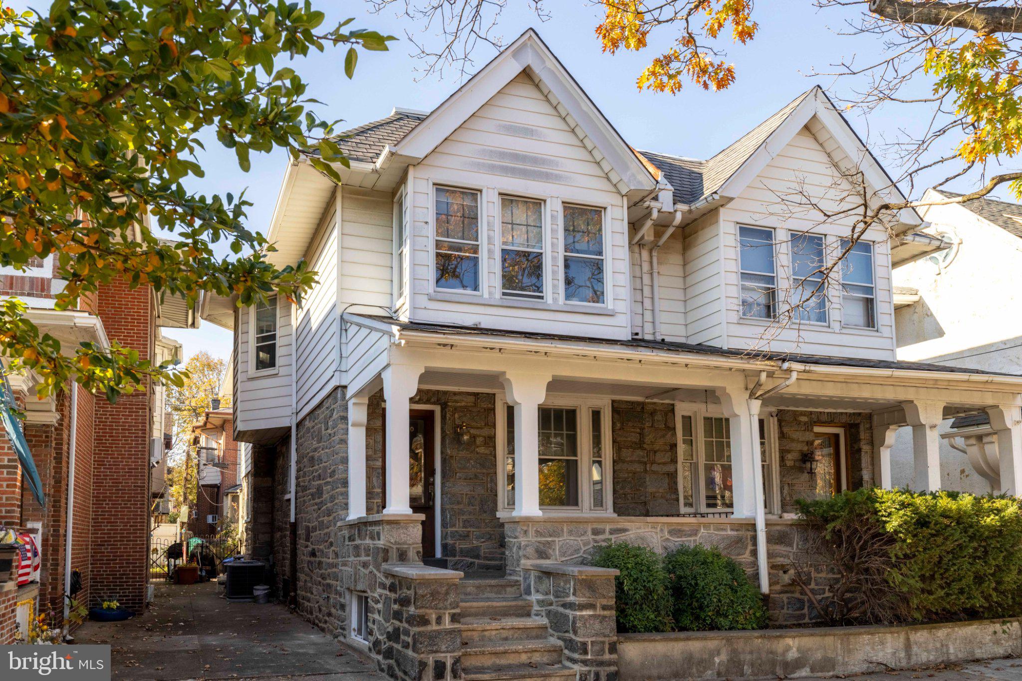 Girard Estates beauty! This 4 bedroom/2.5 bath historic twin on a tree-lined street delivers the charm right away with a covered front porch and vestibule entrance with original wood doors and paneling.  The first floor features a spacious living room, separate dining room, large kitchen and a powder room.  Beyond the kitchen there is a bonus room where the washer/dryer are conveniently located.  The lovely rear patio can be accessed from this room as well.  Upstairs there are four bedrooms and a full hall bathroom.  The front and back bedrooms have gorgeous original wooden built-in closets with mirrors and ornate details.  The partially finished basement level offers more living/working space, another full bathroom and a large cedar closet.  The rear room of the basement has a brand new sump pump, French drains, freshly coated walls and new drain lines. This lovingly maintained home has hardwood floors throughout, tons of character & original details, abundant natural light and great storage/square footage.  Walk a WalkScore of 85 the location can't be beat- the home is just step from shops, restaurants, public transportation and a lovely library.  Super easy access to the stadiums and major highways as well.  Move right in!