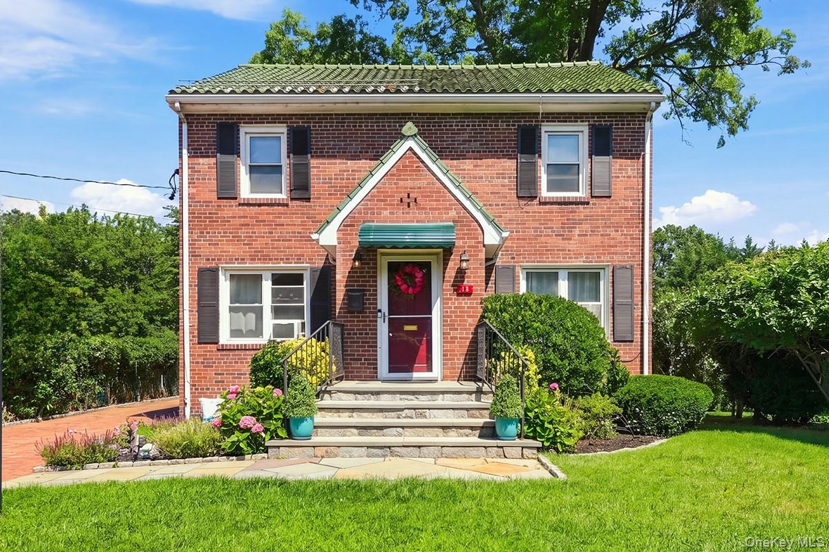 Welcome to 34 Keats Avenue, a beautifully maintained 3-bedroom, 2-bath brick Colonial set on a quiet residential street in Hartsdale's Poets Corner neighborhood. With attractive curb appeal, a manicured yard, hardwood floors, abundant natural light, and a number of thoughtful improvements, this inviting home blends classic character with everyday comfort. The main level features a spacious, sun-filled living room, formal dining room, and an updated eat-in kitchen with tile flooring and backsplash, soft-close drawers, under-cabinet lighting, a newer refrigerator, new garbage disposal, and space for casual dining. Newer windows throughout the home enhance both comfort and natural light. Upstairs are three bedrooms with hardwood floors, including a generously sized primary bedroom. Recessed lighting has been added to the bedrooms, along with updated lighting in the stairway and entry hall. The full hall bathroom features both a separate shower and bathtub. The finished lower level offers valuable additional recreation and storage space, with a large recreation room currently arranged as a family room and home gym, a full bathroom, separate utility area, and direct outdoor access. Outside, enjoy a partially fenced backyard and expansive patio with plenty of room for outdoor dining, entertaining, gardening, play, or simply relaxing. Two backyard sheds provide convenient additional storage, while a front-yard sprinkler system helps maintain the landscaping. The driveway offers convenient off-street parking. Well cared for and full of possibilities, 34 Keats Avenue offers the charm of a classic brick Colonial, flexible indoor and outdoor spaces, and an inviting setting in one of Hartsdale’s established residential neighborhoods.