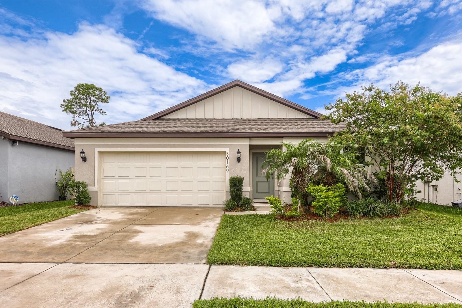 This beautifully designed 4-bedroom, 2-bathroom home offers 1,850 square feet of single-story living space on a premium conservation lot. Nestled within the highly desirable, secure gated community of Wesbridge in Wesley Chapel, this property perfectly blends natural tranquility with modern neighborhood convenience. The interior features a bright, open-concept layout that seamlessly connects the main living areas, dining space, and central kitchen, making it ideal for both daily life and hosting guests. All four bedrooms are generously sized, providing great flexibility for a growing family, a dedicated home office, or guest accommodations. The exterior of the home is defined by its wooded tree line and no rear neighbors. You can take in these serene views from the comfort of your covered rear lanai, which serves as the perfect spot for morning coffee or shaded evening relaxation. The community offers excellent resort-style amenities, including a neighborhood pool, playground, and scenic walking paths. Best of all, the home is situated directly across the street from highly desired local schools and sits just minutes away from Interstate 75, popular shopping hubs, and local dining destinations.