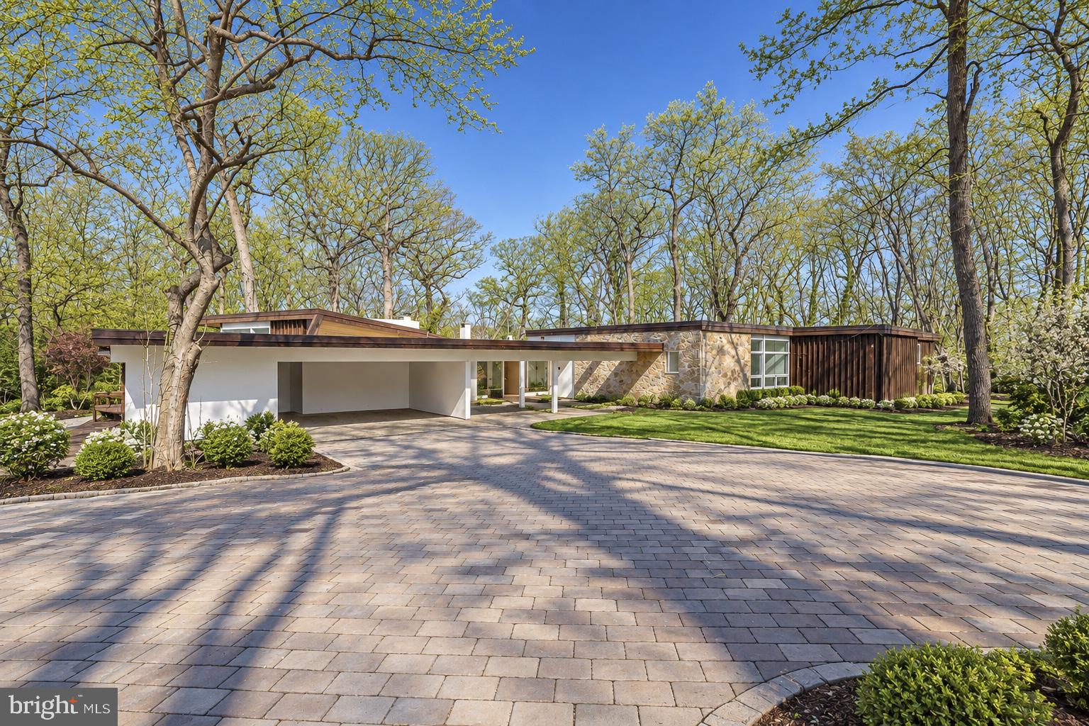 A Rare Opportunity in Penn Valley – Historic Mid-Century Modern Home on 2.33 Acres with an Included, Separately Subdivided 1.07-Acre Building Lot! Live in this extraordinary Mid-Century Modern home while building your dream home on the included, adjacent 1.07-acre building lot! Nestled along one of Penn Valley’s most desirable roads, 39–41 Fairview Road presents a truly unique opportunity with endless possibilities. Set on 2.33 acres of beautifully wooded grounds, this remarkable property includes the existing residence on 1.26 acres, plus an additional 1.07-acre subdivided lot. Whether you envision building a spectacular new residence while enjoying the comfort of the existing home, creating a multigenerational family compound with two homes side by side, or simply preserving the exceptional privacy and serenity of the expansive grounds, this one-of-a-kind property offers incredible flexibility and potential. Surrounded by lush, mature trees and beautifully integrated into its natural setting, the historic Mid-Century Modern residence showcases distinctive architectural details, impressive living spaces, and walls of glass that seamlessly connect the indoors with the surrounding landscape. The striking stone exterior, private front courtyard, and double carport are complemented by subtle earth tones, setting the stage for the home's timeless design. Upon entering, you are welcomed into an impressive living room featuring new tile floors, soaring ceilings, recessed lighting, dramatic floor-to-ceiling windows, a unique curved fireplace, and sliding glass doors opening to an expansive deck overlooking the peaceful grounds. The spacious dining room, ideal for both intimate gatherings and large-scale entertaining, features high ceilings and sliding doors leading to a beautiful stone patio. Flowing effortlessly from the dining room is the updated eat-in kitchen, complete with a large center island, high-end appliances, abundant cabinetry, a generous breakfast area, and an expansive wall of windows that fills the space with natural light. Access to two separate stone patios further enhances the home's exceptional indoor-outdoor living experience. A long, closet-lined corridor leads to the spacious primary suite, a private retreat featuring three walk-in closets and an ensuite bathroom with a double vanity, soaking tub, and glass-enclosed shower. Sliding glass doors open to a tranquil atrium and connect to a private den or home office featuring a wall of custom built-ins. Five additional generously sized bedrooms, each offering ample closet space and natural light, include one with an ensuite bathroom, while an additional full hall bathroom completes this level. The finished lower level offers even more versatility, with a private bedroom and full bathroom, making it ideal for an au pair, extended family, guests, or a potential in-law suite. One of the home's most distinctive features is the large indoor swimming pool, providing an exceptional space for year-round swimming, exercise, relaxation, and entertaining. Outside, expansive decks, stone patios, and the peaceful wooded surroundings create an idyllic setting for outdoor gatherings or quiet enjoyment. Ideally located in the award-winning Lower Merion School District, this exceptional property offers convenient access to shopping, dining, entertainment, major roadways, public transportation, and Center City Philadelphia. Any future construction or development is subject to applicable township approvals and requirements. An exceptional opportunity to own a piece of Penn Valley's architectural history, with the land and flexibility to create your vision for the future. Properties offering this combination of distinctive Mid-Century Modern architecture, privacy, acreage, and an additional subdivided building lot are rarely available. Don't miss your chance to own 39–41 Fairview Road!