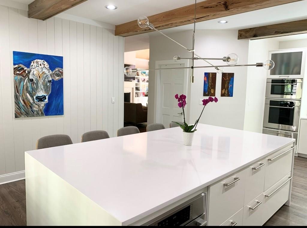 Exquisite 5-Bedroom Home with Modern European Flair and Stunning Views!  Located at the back of a quiet cul-de-sac in one of the most sought-after neighborhoods, this beautifully updated 5-bedroom, 3.5-bathroom home (plus a 1/1 detached garage apartment!) offers the perfect balance of modern elegance, exceptional functionality, and serene surroundings. Set on a spacious, wooded 1.14-acre lot, this property not only boasts a luxurious interior but also provides an ideal location with Brookwood School less than 4 minutes away. Gourmet Kitchen & Living Areas: Step into the heart of the home, where a Modern European kitchen steals the show. Featuring top-of-the-line appliances including full-sized Subzero fridge/freezer, Wolf steam and convection wall ovens, Wolf gas range with griddle, Bosch convection oven/microwave combo, and Cove dishwasher, this kitchen is every chef's dream! Pecky cypress beams and painted tongue-and-groove details enhance the space with rich textures, while quartz countertops and a stunning 9x5 cascading quartz island provide plenty of prep space. Two oversized 4x6 windows bring in plenty of natural light and capture the beautiful views of the surrounding landscape. The living room, with its soaring vaulted tongue & groove ceiling, is equally impressive offering a cozy ambiance with a wood-burning fireplace (gas starter), perfect for evenings at home. Built-in bookshelves provide elegant storage, enhancing both form and function. The home has been meticulously updated with modern interior lighting, fixtures, switches, and fans throughout. Bonus Room & Master Suite:  Enjoy an additional spacious 1/1 apartment (460 sqft) above the detached garage. This versatile space is finished with real wood plank paneling and includes a fully renovated bathroom and LVP flooring making it ideal as a guest suite, media room, home office, or exercise room. The master suite is a sanctuary, with a separate sitting room or office area, built-in bookshelves, and a beautifully appointed bathroom that boasts a custom-built floating vanity, free standing tub for two, oversized walk-in shower with rain can, and closet with custom built-in drawers & shelving. Outdoor Living & Grounds: Step outside to the newly updated back deck with cables that wraps around the living area, offering a seamless transition to the lush, private backyard. Enjoy outdoor living with front and back porches, a stream running at the back of the property, and easy access to the pool and clubhouse just up the street!  Extra Features & Amenities: This home includes a whole house water softener system, reverse osmosis drinking water filtration system, and encapsulation with dehumidifier to ensure comfort and quality. The climate-controlled storage in the garage features wall-mounted bike racks and custom cabinetry, while the wired workshop (14X16) provides ample space for all your lawn equipment and power tools. Special Updates: A new roof (2018), exterior paint, new carpet in upstairs bedrooms, and new shed ensure that this home is as functional as it is beautiful. The bar area has been updated with a sleek quartz countertop and new cabinet doors making it perfect for entertaining. This stunning home truly combines luxury, practicality, and beauty. With its meticulously maintained interiors, exceptional location, and breathtaking surroundings, it is sure to be the perfect retreat for its next owners!  Sellers are licensed Realtors in the state of GA #369599 & #391145