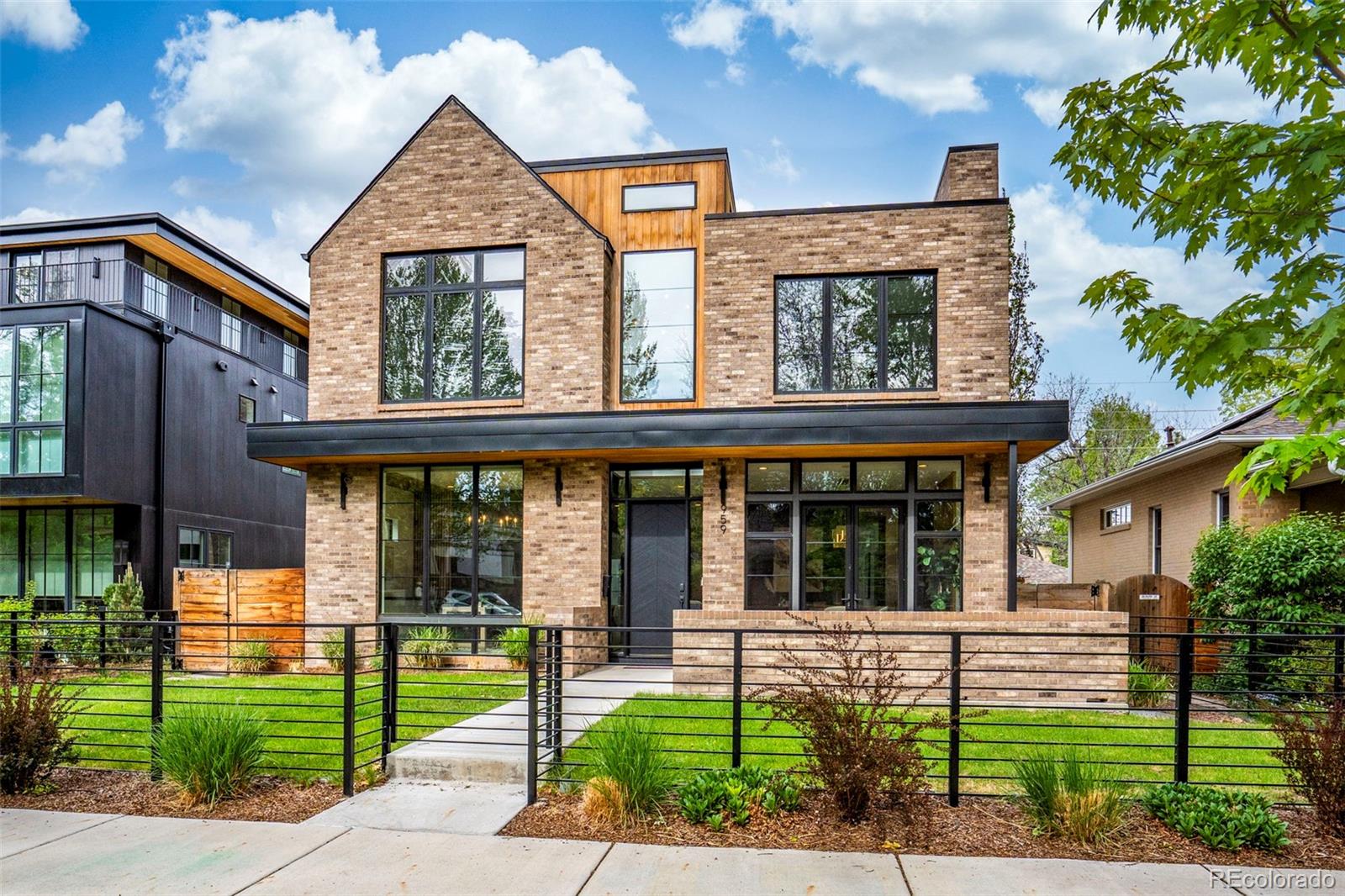 Experience the pinnacle of contemporary luxury in this masterfully crafted architectural gem, situated in the heart of Denver’s prestigious Washington Park. Completed in 2023, this residence is the result of a premier collaboration between Devex Construction, Goerig Design Architecture, and Coesivo Design Group. Every inch of the 5,211-square-foot floor plan has been meticulously designed to blend chic elements with warm, sophisticated finishes, all set against a backdrop of dramatic floor-to-ceiling windows and 8-inch wide French oak hardwoods.The main level serves as the ultimate stage for both grand entertaining and comfortable daily living. At the heart of the home, a chef’s dream kitchen is anchored by a massive 10-foot waterfall island and a suite of high-end appliances, complemented by dual pantries for seamless organization. The Great Room, anchored by one of the home's three elegant gas fireplaces, transitions effortlessly to the outdoors through 12-foot bi-fold doors. This leads to a private, professionally landscaped rear patio featuring a custom pergola and firepit, perfect for Colorado’s crisp evenings.The upper level is defined by a custom steel staircase with butcher block treads that leads to the primary suite. This retreat boasts its own private fireplace, custom-designed walk-in closets, and a spa-like five-piece bathroom. Below, the fully finished basement expands the living space further, offering a media room with surround sound, a wet-bar, a chic wine storage area, and a dedicated exercise room to accommodate a modern, active lifestyle.Beyond the home’s stunning interior, the location offers an unparalleled Denver location. Positioned on a pristine 6,300-square-foot lot, you are just blocks away from the lush greenery of Washington Park as well as shops and dining offerings of the Old South Gaylord district. This property represents a rare opportunity to own a modern masterpiece in one of the city's most coveted neighborhoods.