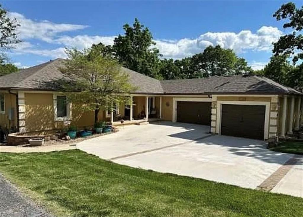 Beautiful Lake Winnebago lakefront home is ready for year round lake life! Located in a quiet cove with good water and a double decker dock. The newly remodeled chef's kitchen with a 10' island, living and dining room speaks for itself, with amazing views of the lake from sunrise to sunset. Stunning brazilian wood floors throughout the main living areas. Also on the main level is a beautiful sun room, master bedroom suite along with 3 other bedrooms, full and half bathroom and laundry room. The walkout basement features a second full kitchen, family room and pool table, fireplace, 2 more bedrooms and 1 full bathroom with lots of storage areas. This home could easily be a multi generational home too. The exterior of the home is stucco with hardy board siding with vinyl soffits and fascia along with a sprinkler system that uses water from the lake. The whole house GE generator also stays with the home. The 3rd car garage with this home is 13x32' for boat, car or golf cart storage. The backyard has a 2 level deck, along with a covered and uncovered patio area. The double decker dock with composite decking and boat lift are included. Lake Winnebago is a community that offers many types of watersports along with year round community events, including the St Patty day parade, 4th of July Ski show and Winterfest just to name a few. There are various social and hobby clubs that you can join! The Arrowhead Yacht Club is open for dining and entertainment and hosts many community events through out the year. There are also trails to walk on, a park with tennis and pickleball courts, playground equipment, shelter and restrooms, and coming in 2026 - the new community pool! This home also has an assumable VA loan!