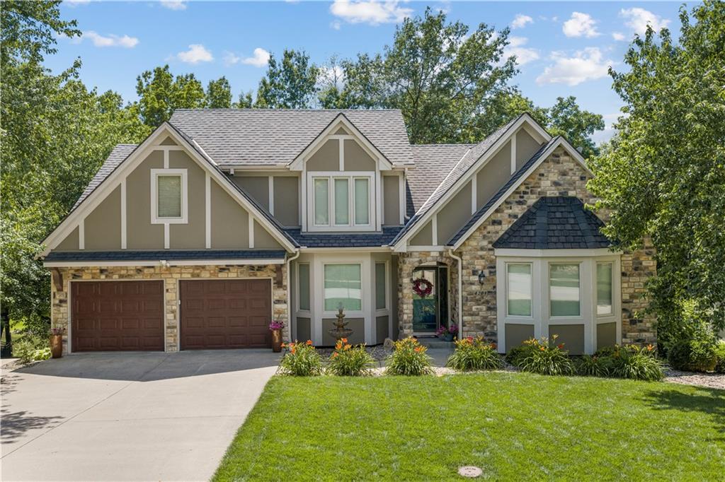 Rare opportunity to own a stunning lakefront home in Lakewood! Situated on a peaceful cove, this updated 5-bedroom, 1.5-story home offers modern style, timeless charm, and gorgeous waterfront views.You'll love the inviting curb appeal and warm, elegant interior. Hardwood floors, soaring ceilings, and floor-to-ceiling windows across the back of the home showcase the view and fill the space with light. The main level features the primary suite and a second bedroom, currently used as an office, making one-level living easy and convenient.The recently renovated primary bath is like a private spa with a walk-in shower, double vanities, and stackable washer/dryer. The remodeled full bath on the main level adds more style and functionality. The kitchen is designed for gathering, featuring a brick fireplace, granite island, walk-in pantry, and double patio doors leading to the expansive deck overlooking the lake. It's the perfect spot for morning coffee or relaxing at sunset.Upstairs you'll find two spacious bedrooms with walk-in closets and a connected full bath. There's also a loft, ideal for a library, study area, or play space.The walkout lower level is an entertainer's dream. A large custom bar with seating for up to 10 includes a wine fridge, ice maker, refrigerator, sink, and extensive cabinetry. There's plenty of room for a game or pool table, or watching TV with friends. The media room includes comfy recliners and a projector for movie nights. A fifth bedroom offers two walk-in closets, built-in bookshelves, and private exterior access. There's also another full bath with shower.Step outside to the covered patio featuring a hot tub and TV area. The backyard gently leads to the lake, making kayaking, paddleboarding, and fishing available just steps from your door. A mudroom provides convenient storage for all your lake gear.Lakefront homes like this rarely come available in Lakewood. Active June 27 and Open House June 28, 1-3pm!