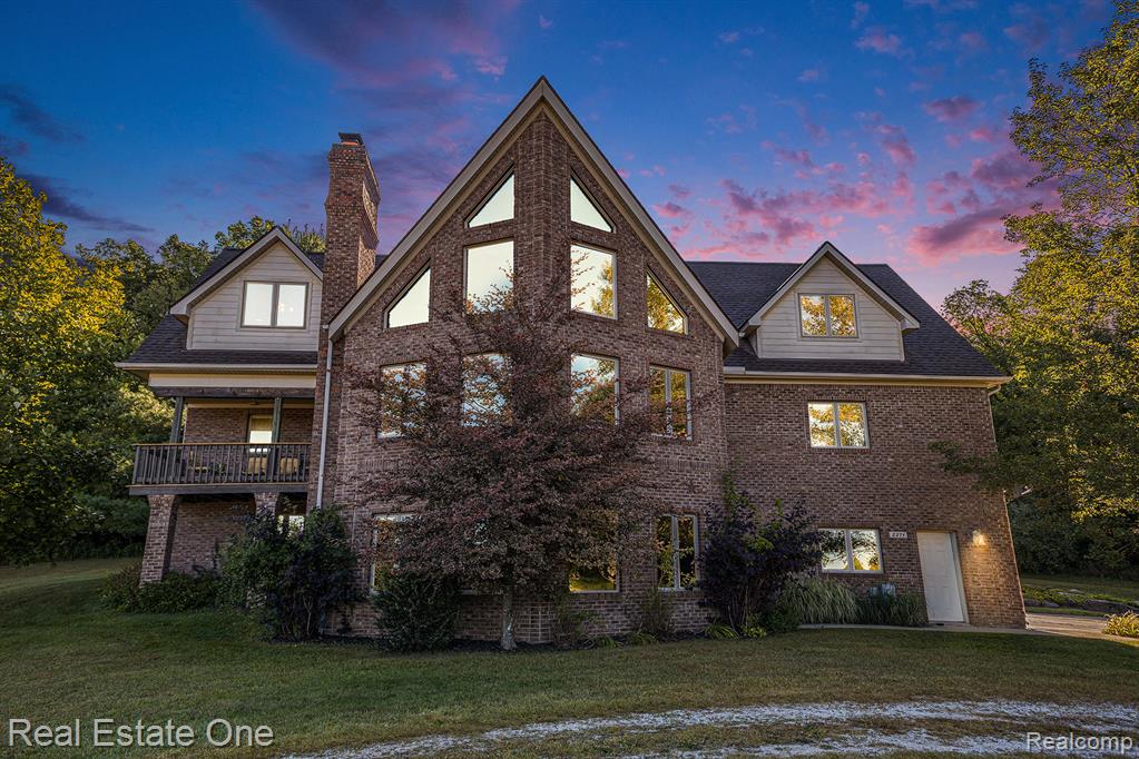 Have the best of both worlds—peaceful country living on 5 acres, just minutes from Downtown Milford & Brighton! This stunning property offers over 5,300 sq. ft. of fin living space designed for comfort, flexibility, & unforgettable views. The home was intentionally crafted to capture the most incredible sunsets year-round, w/ soaring timber-framed, vaulted ceilings & natural fireplace in the GR that bring a true “up north” feel right to your doorstep. Exposed beams t/o add warmth & character, making this a truly one-of-a-kind design. On the main floor, a suite w/ Jack-N-Jill access to the full bath could serve as a private office/guest space. Across the home, you’ll find a spacious 800 sq. ft. bedroom w/ plumbing beneath the floor—ideal for transforming into a luxurious primary suite or even multiple bedrooms with a shared bath. Separating these spaces is the gourmet kitchen. It's a chef’s dream, complete w/ Viking appliances, granite countertops, & a walk-in pantry featuring an add'l refrigerator & storage. Upstairs, discover an inviting loft, full bath w/ jetted tub & separate shower, convenient laundry rm, & a generous primary bedroom retreat. There is a door space at bottom of stairs that is just drywalled over to make direct access to full w/o basement. It is like its own private home, w separate entrance, laundry closet, cozy living room w/fireplace, dining nook, full kitchen & bath. Radiant floor heat keeps the space warm in cooler months—perfect for multi-generational living, older children at home, or rental income opportunities. Outside, the property shines with a massive 40x80 pole barn with electricity, ready for your favorite hobby—whether it’s working on cars, woodworking, or creative projects. Sit back and relax on the upper covered porch off the living room as you drink a cup of coffee & contemplate the day. This home truly offers flexibility, space, & endless possibilities—all wrapped in the beauty of country living just minutes from everything.