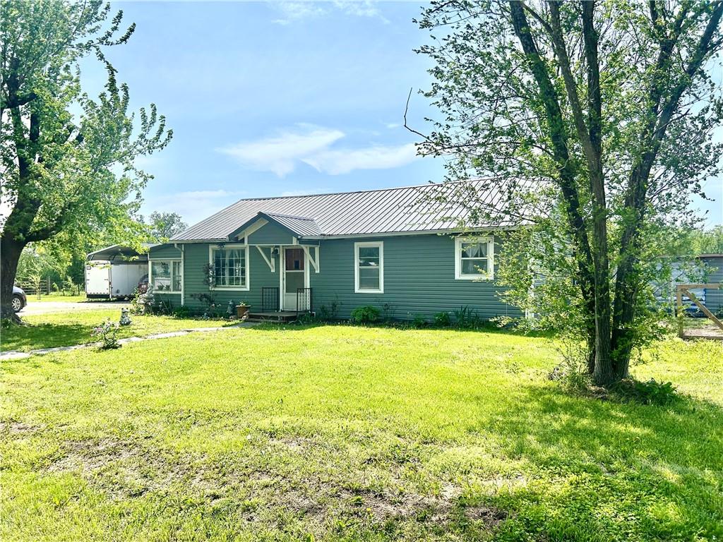 GREEN ACRES FOR YOU!! 6.9 acres with a newly remodeled 2 bed 1 bath all one level home. Open floor plan living and dining to kitchen. Large bedrooms can accommodate an office or exercise area. Fully redone bath with pex plumbing. New water heater. All new flooring throughout. The east entrance is a large sun room porch for plant lovers or projects, workout, or additional space of choice. The west lawn is fully fenced for pets or chickens in this case with a coup. A covered back deck will give you sunset views and the green acres behind. Extra large carport stays. Small town of Walker only 7 miles from major shopping. Come see this country gem!