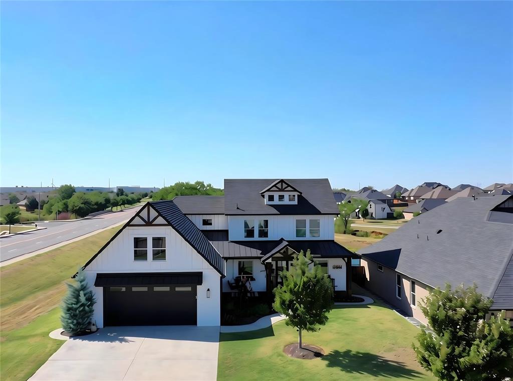 Custom-built in 2019, this move-in-ready modern farmhouse in NE Norman's Vintage Creek blends striking design with everyday luxury! Soaring 10-foot ceilings, abundant natural light and an open layout create an inviting space for living and entertaining. The chef's kitchen shines with a large granite island, custom soft-close cabinetry and Frigidaire Professional appliances, including a commercial-style refrigerator. Retreat to the main level primary suite with a spacious closet and executive 9-foot shower with twin rainfall showerheads. Upstairs offers two bedrooms, a full bath and a flexible second living area. Enjoy sunrise and sunset views from the covered patios, plus a 6-zone sprinkler system and exterior eave lighting. Thoughtful upgrades include Low-E WeatherBarr windows, a 2022 roof with Class 4 impact-resistant shingles, tankless hot water system and a 680-SF garage with access to a massive stand-up storage attic. Meticulously maintained and ready to welcome you home!