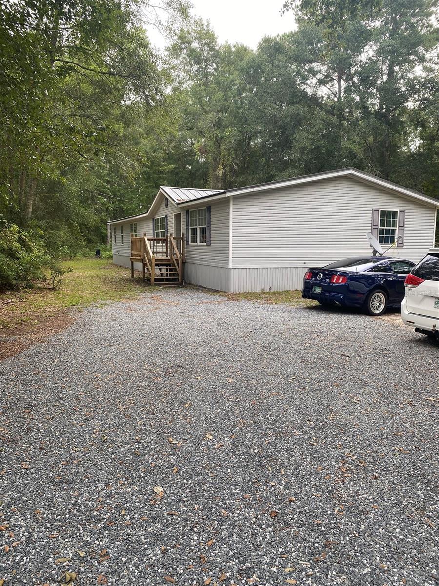 For sale by owner as is 2000 mobile home remodeled 4 bedroom 2 bath. 2025 new metal roof, new underpinning, new hot water heater, new power  pole, new bath fitter shower and bath tub and 50 amp generator inlet box for storms and power outages. Peaceful and private. 3 acres you could build a a new home and have rental property or a place for family. Close to I-10 and Hwy 90 easy commute to work. Mile and a half from Buck Lake Road.
