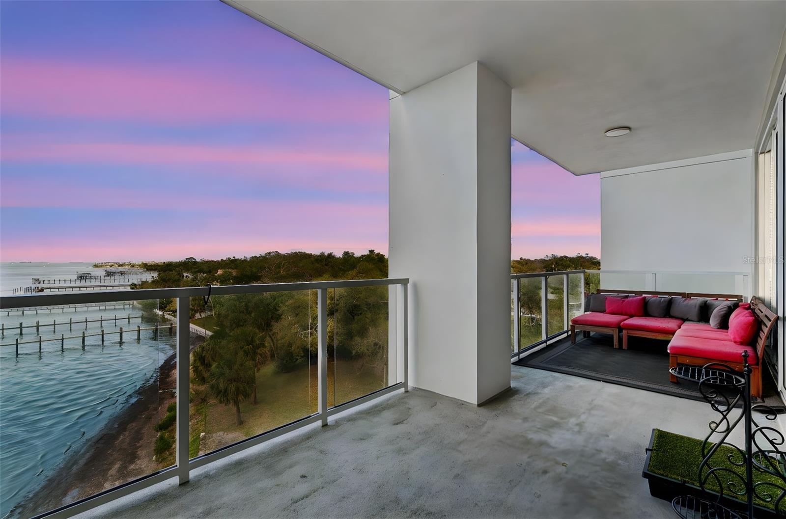 Sellers will assist with 6 months of HOA dues. Spectacular waterfront living awaits at Marina Bay. This designer-appointed residence offers sweeping views of Clearwater Bay from an expansive private balcony—one of only two of its kind in the building—creating a rare opportunity to enjoy elevated coastal living with minimal direct sun exposure for comfortable year-round enjoyment. Built in 2021, this beautifully upgraded 2,003-square-foot home features two bedrooms, two baths, and a versatile den ideal for an office or guest space. Elegant finishes include upgraded tile flooring, crown molding, new carpet (2024–2025), custom closets, and commode cabinetry. The chef’s kitchen is thoughtfully designed with all-wood cabinetry, quartz countertops, stainless steel appliances, a reverse osmosis water system, and water softener.  The serene primary suite offers professionally designed closets, electric blinds, and a spa-like bath with a walk-in shower. Electric blinds are also featured in the guest bedroom for added comfort and convenience. Hurricane-impact windows provide peace of mind, while recent mechanical upgrades include a new air conditioner (2024–2025) and an upgraded water heater with a safety shutoff device. Accessible from the living room and both bedrooms, the extended balcony creates a seamless indoor-outdoor living experience perfect for enjoying breathtaking sunsets over the water.  Residents of Marina Bay enjoy a true resort lifestyle with 24/7 concierge service, a 25-meter saltwater lap pool, fitness center, sauna and steam rooms, billiards room, and putting green. The adjacent marina offers 69 slips (47 with lifts) with priority leasing opportunities for residents. Located just minutes from Clearwater’s world-famous beaches and vibrant downtown, this exceptional residence offers luxury, comfort, and convenience in one of the area’s most desirable waterfront communities. Furnishings may be negotiated separately.