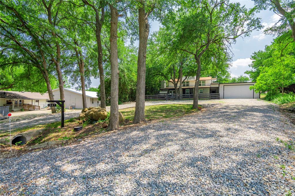 Nestled among towering mature trees in a quiet, established neighborhood near Lake Texoma, this beautiful fully furnished, updated 4-bedroom, 2.5-bath home offers 3,063 square feet of comfortable living space designed for relaxation and entertaining. The spacious open concept floor plan features an oversized kitchen with abundant cabinetry, double ovens, electric range, expansive quartz countertops, a large breakfast bar, and generous dining space that flows seamlessly into the inviting living area.The home's thoughtful layout provides ample room for family and guests, while large windows throughout bring in natural light and showcase the surrounding wooded setting. A decorative fireplace serves as a charming focal point, creating a warm and welcoming atmosphere.Outdoor living is equally impressive with a large deck perfect for gatherings, a hot tub for year-round enjoyment, and a covered third-floor patio offering a peaceful retreat among the treetops. Whether enjoying morning coffee, evening sunsets, or entertaining friends, the outdoor spaces provide multiple options to relax and unwind.Additional features include a huge 28 x 40 garage perfect for all your lake toys, ample parking, and a serene setting that feels tucked away while remaining conveniently close to Lake Texoma's boating, fishing, dining, and recreational opportunities. This property offers the perfect combination of space, comfort, and natural beauty.