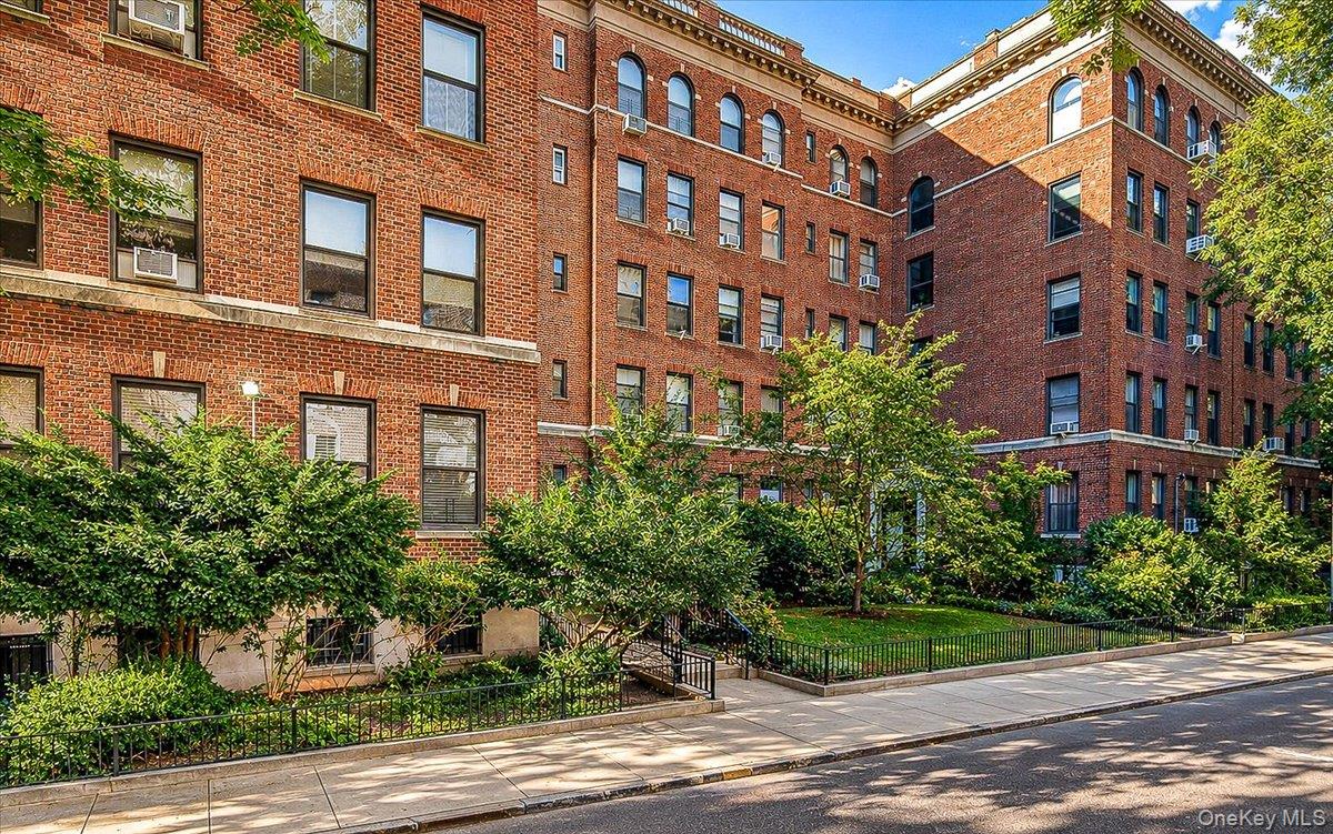 Architectural Elegance with a Rare Wood-Burning Fireplace at Laburnum Court in Jackson Heights!Welcome to this beautifully reimagined pre-war residence in the heart of Jackson Heights’ coveted Historic District. Combining timeless architectural character with thoughtful modern updates, this expansive two bedroom, one bath coop has been meticulously redesigned to maximize space, light, and functionality.Sunlight pours through five oversized windows spanning the open living and dining area, where an eastern exposure with a touch of southern light fills the room with warmth. This inviting space is ideal for both everyday living and entertaining. At the center of the room, a restored wood-burning fireplace with its original mantel, Crema Valencia marble surround, and mosaic marble hearth serves as a stunning focal point. Rich pre-war details, including nine-foot ceilings, original oak parquet floors with mahogany and maple inlays, elegant moldings, and classic French doors, add warmth and character throughout. A generous entry foyer offers a warm first impression and provides flexibility for a home office, reading nook, or additional storage, complete with an oversized coat closet and custom architectural feature wall. The custom-designed windowed kitchen overlooks the building’s beautifully landscaped garden and has been thoughtfully planned for both style and efficiency. Quartz countertops, stainless steel appliances, a classic, deep-basin sink and faucet, custom cabinetry, open shelving, a built-in pantry, and dedicated broom closet provide abundant storage and workspace. Cork tile flooring offers both comfort and durability, while a distinctive architectural partition with Ronchamp-inspired cutouts allows natural light to flow effortlessly between rooms. Privately tucked away beyond the original glass French door are two generously proportioned bedrooms, each featuring large west-facing windows overlooking the garden and ample closet space. The windowed bathroom is well maintained with ceramic tile finishes, chrome fixtures, and a new modern vanity.Laburnum Court is one of Jackson Heights’ most distinguished landmarked cooperative residences. Designed by renowned architect George H. Wells in the early 1920s, this Neo-Georgian elevator building is centered around a beautifully landscaped private garden, with every apartment featuring a wood-burning fireplace, a rare and highly sought-after amenity. Residents enjoy a live-in superintendent, laundry facilities, bicycle storage, and private storage (waitlist). Perfectly situated just moments from the vibrant shops and restaurants along 37th Avenue, the building also offers exceptional access to transportation, including the 7 train at 82nd Street and the E, F, M, R, and 7 trains at 74th Street/Roosevelt Avenue. Cats are welcome; sorry, no dogs.