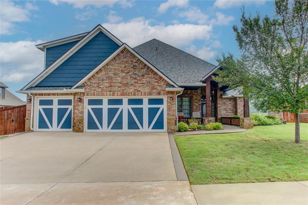 Welcome home to comfort, character, and exceptional design in the highly sought-after Hallbrooke addition! From the moment you arrive, the inviting curb appeal and front porch sets the tone for this beautifully crafted home. Inside, you’ll find wood floors throughout the living area and sitting room, complemented by travertine tile and rich, detailed woodwork that adds warmth and elegance at every turn. The sitting room features sliding barn doors and a striking wood accent wall, creating the perfect flex space with style. The living room centers around a cozy fireplace and flows seamlessly into the kitchen. Designed for both everyday living and entertaining, the kitchen boasts shaker style cabinets, granite counters, built-in appliances, a pot filler over the stove, a large island, pull-out trash can, and two walk-in pantries. Once you experience the soft-close cabinet doors and drawers, you’ll never want anything else. The thoughtfully designed floor plan offers exceptional functionality. The master suite is a true retreat with a spacious walk-in closet, double vanities, a jetted tub, and a step-in shower. A secondary bedroom offers its own full bath and walk-in closet, while the third and fourth bedrooms share a convenient Jack-and-Jill bathroom. The utility room doubles as a mudroom and provides incredible storage with built-ins, ample granite counters, a sink, walk-in closet, and mud bench—perfect for keeping life organized. Upstairs, you’ll find an impressive L-shaped bonus room, a dedicated theater room with built-in speakers, and a half bath—ideal for movie nights, game days, or a private getaway space. Outdoor living is just as impressive with a huge, covered patio featuring an outdoor kitchen and retractable blinds. This home has so many recent updates and valuable upgrades: upgraded HVAC in 2023, class 4 roof, gutters, and exterior paint in 2022, epoxy garage floor, storm shelter, outdoor built-in grill, granite counters, mounted TV, and power shade.