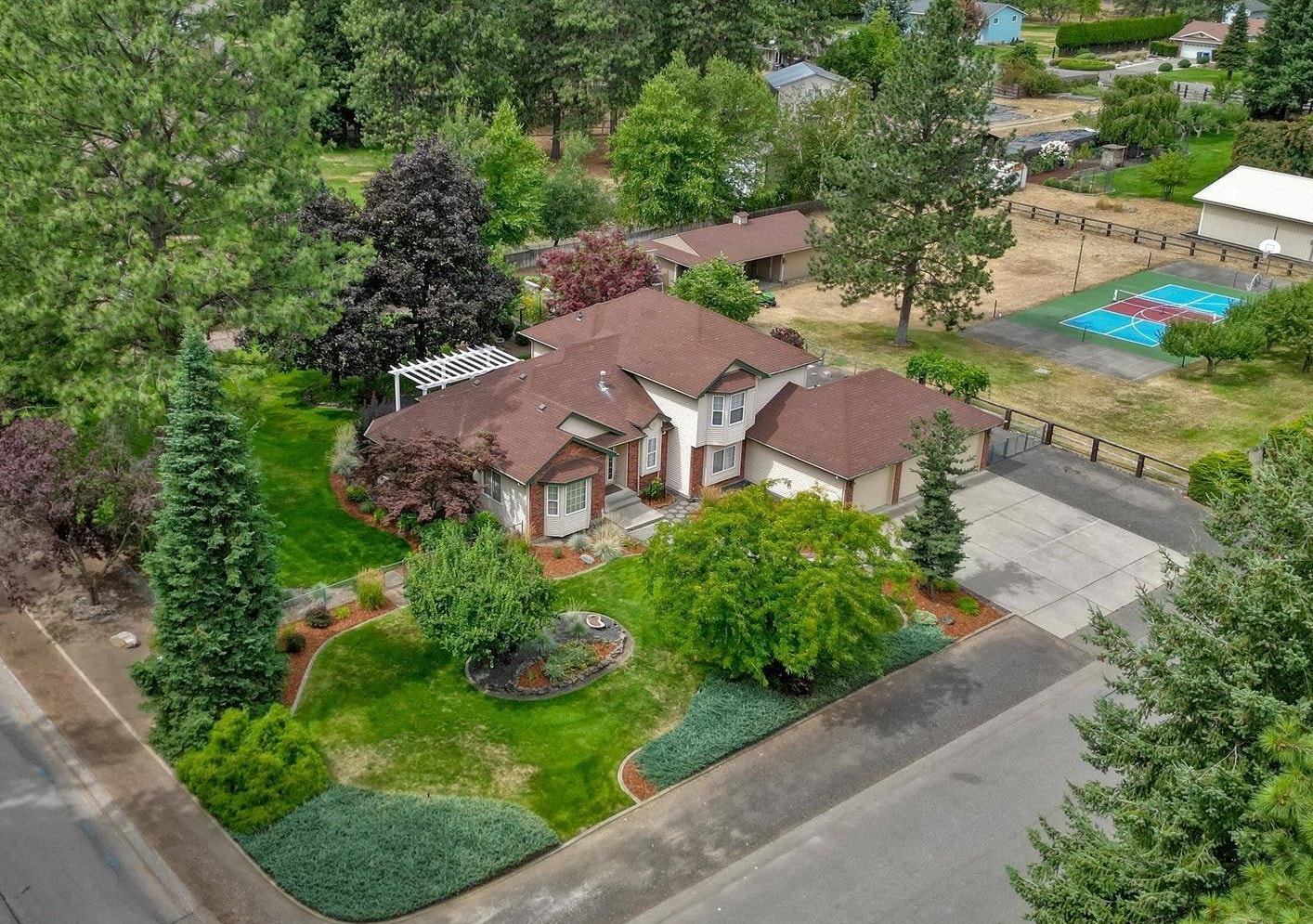 This outstanding Ponderosa home features 4 Bedrooms, 4 bathrooms with room to grow in the unfinished basement. Kitchen was updated in 2019 with new appliances, quartz counters & backsplash including a spacious island and pantry. Both formal and informal eating spaces. Family room off kitchen with fireplace with built ins, surround sound and outside entrance plus there is a formal living room. Spacious Primary Suite with walk in closet, double sinks, jetted tub and shower. Giant laundry room is right off garage and has it's own laundry chute. Not only is there a 3 car attached garage, there is an 880sf detached garage/shop plus room to build a giant shop! Extensive garden area including a greenhouse and tons of fruit... raspberries, cherries, blueberries and apples, plums, grapes & blackberries. PICKLEBALL & basketball.... this lighted sport court is set up for hours of entertainment. Bring your animals and all your toys. There is room for it all!!