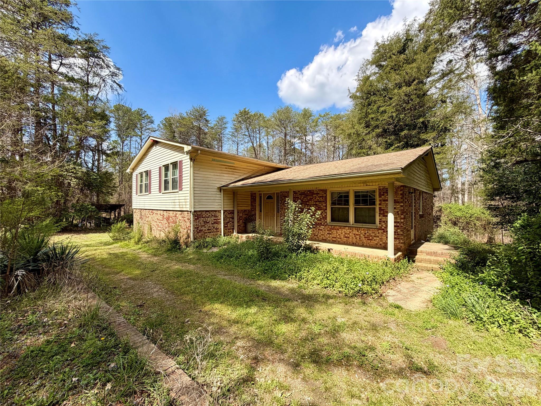 Fantastic opportunity located in the shadow of Crowder’s Mountain & near the access point of Crowder’s Mountain State Park! Nestled within almost 5 acres, this exceptional property offers a rare combination of privacy, natural beauty & versatility. At its heart lies a split level home ready for renovation (or possibly a teardown to build your own estate). House features 4 full bedrooms, 2.5 baths with a 1 car garage providing a picturesque setting for whatever you can dream of. Property also offers ample space to expand & grow & presents an excellent opportunity for multi-generational living, guest accommodations or rental income while allowing flexibility for future ownership options. Whether you’re seeking a peaceful family estate, an income-generating investment, or a private getaway, this unique property delivers unmatched potential in an unbeatable location. Come enjoy country living while also being close to the new Kings Mountain casino & the future Linwood Springs recreation park. Recently a 3 acre lot directly across the street sold for $250K & new construction smaller lots on the street have sold over $750K. A rare gem!