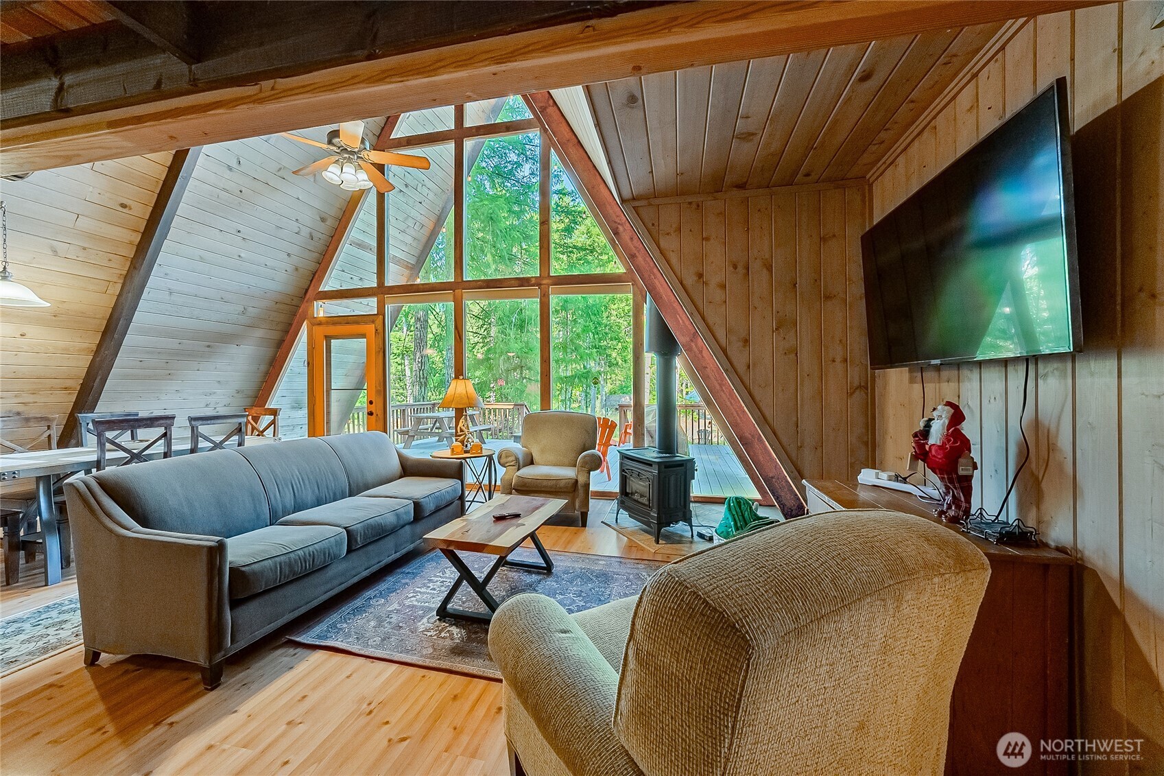 Tucked into the trees on two lots in Packwood’s desirable Timberline community, this classic A-frame delivers the mountain retreat buyers come here to find. Soaring vaulted ceilings, warm wood finishes and an open great room create an inviting gathering space after a day at White Pass or Mt. Rainier. The flexible 3-bedroom layout includes two bedrooms on the main level plus a spacious loft, along with two baths.    Outside, nearly half an acre offers room to relax and entertain with two decks, a private hot tub and two storage sheds surrounded by the natural beauty of the Cascades. Timberline residents enjoy community pools, athletic courts, clubhouse, park, playground and river access.    Just minutes from downtown Packwood and approximately 20 miles from White Pass Ski Area, this property puts year-round recreation close at hand. Offered turnkey with existing short-term-rental use, it is equally suited as a personal mountain escape, full-time residence or income-producing getaway.