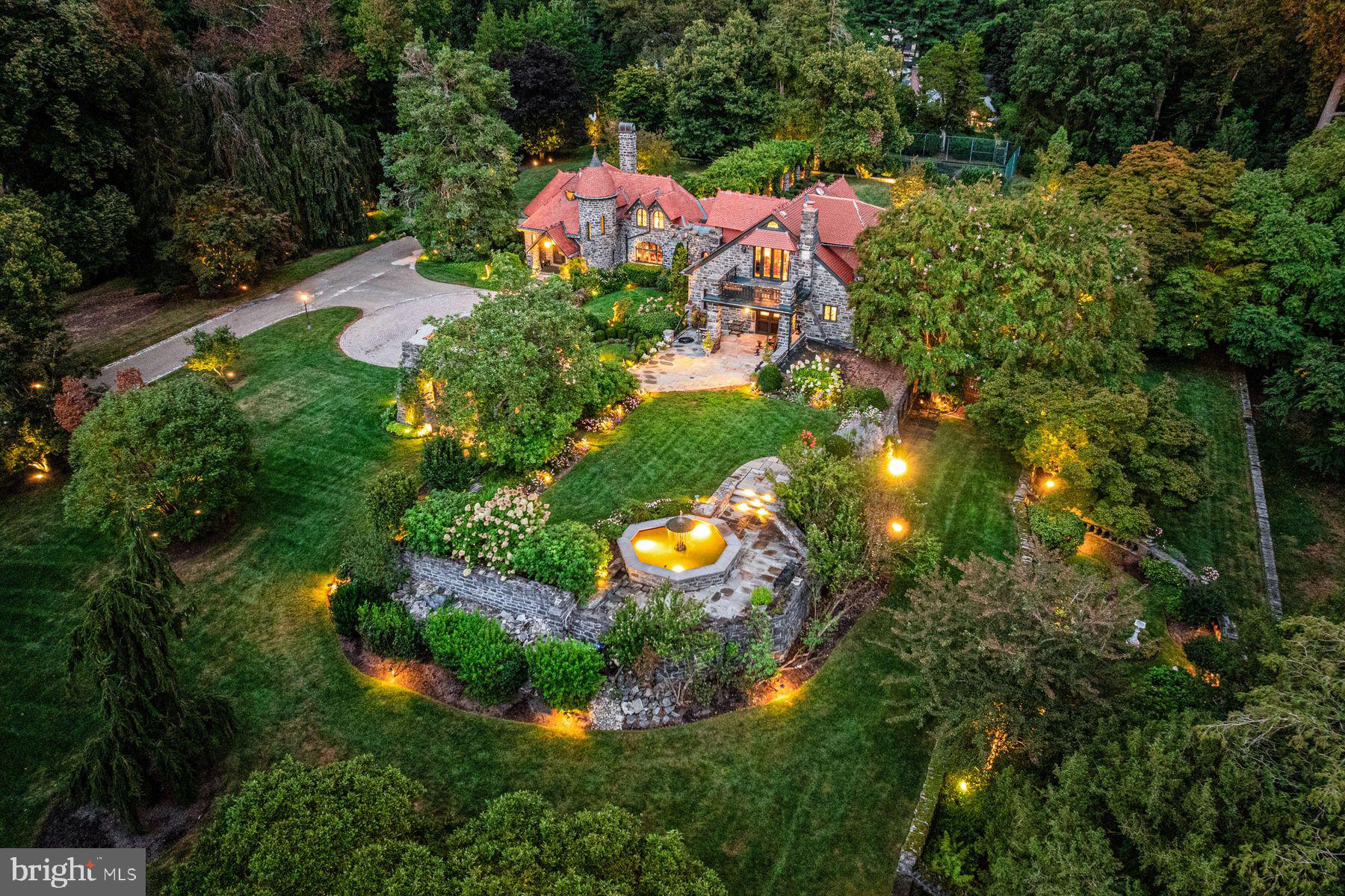 WOW!!! This incredible Radnor estate built in 1882, was once known as Fox Hill Farms and was originally sited on 560 glorious acres at the highest point in Bryn Mawr. Now set on 5 beautifully landscaped private acres with flowering perennials, specimen trees and breathtaking views, the fabulous stone main residence with tile roof, separately deeded charming guest/ gate house and tennis court await their next lucky stewards, with both parcels being included in this listing.  The current owners have meticulously restored the original architectural designs and materials, while completely modernizing the infrastructure and amenities of the residences including updated HVAC, electrical systems, new generator and more. Endless features that afford comfortable everyday living and easy entertaining include sun-filled leaded glass arched and eyebrow windows, fabulous wide plank floors, massive mahogany moldings and millwork, gracious entrance foyer, soaring great room ceiling with restored log beams and walk-in Philadelphia brownstone fireplace, expansive dining room with hidden wet bar private office, large cherry eat-in kitchen with prep island, gas cooktop, double ovens, SubZero refrigerator, breakfast room and enormous "icebox" pantry, 2 first floor powder rooms, cozy family room off of kitchen area and a generous first floor guest bedroom suite with full bathroom. The main staircase is dedicated to a spacious second floor Primary Suite with gracious bedroom opening up to 2 balconies with glorious views of the gardens, grounds, terraces, stone walls, flowering pergola and water fountain, 2 customized walk-in closets, sitting room with fireplace, luxurious bathroom with sunken tub, walk-in frameless glass shower and separate commode room. A second staircase leads up to a third bright bedroom suite with bright bedroom and bathroom featuring endless views of the jaw dropping grounds. The dry, partially finished lower level offers a potential 4th bedroom with full bathroom, exercise area, laundry room and lots of storage The stately guest/ gate house also offers private living or working spaces with a potential 5th bedroom, full bathroom, kitchen and living/ dining room.  This incredible, one-of-a-kind historic oasis offers endless opportunities for expandable spaces to suite any buyer's desires. Close to renowned Radnor schools, and private schools and universities, a wide variety of recreational facilities, clubs, all forms of transportation, wonderful restaurants, Philadelphia Airport and more. A rare jewel!! LOW TAXES!