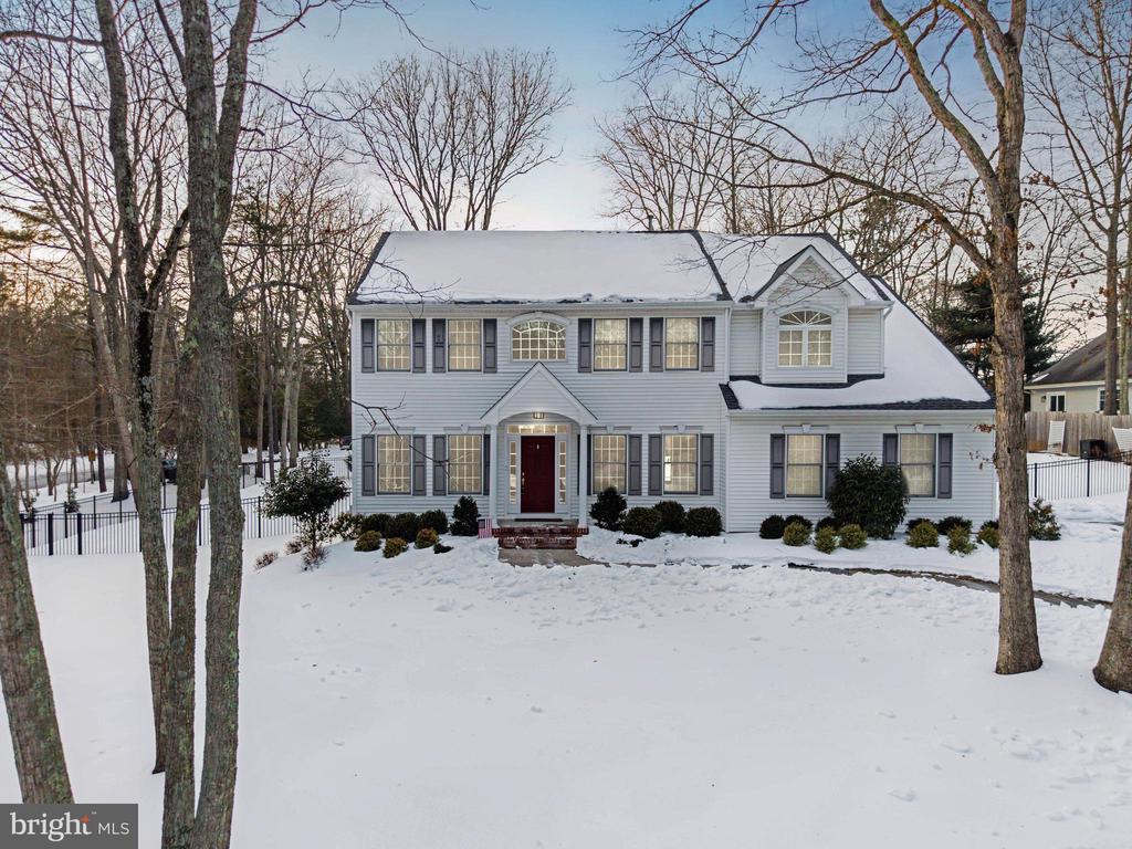 Welcome to a beautifully updated Center Hall Colonial set among the tree-lined streets of the highly sought-after Tamarac community in Medford — where neighborhood charm meets private lake living. Built in 1997 and located on one of the newer construction sections of Tamarac, this home offers the space everyone wants with the upgrades today’s buyers appreciate. Freshly painted throughout with designer accents, molding details, and updated flooring, the interior feels warm, refined, and move-in ready while still offering room to grow. The main level features spacious formal living and dining rooms, a dedicated home office, convenient mudroom/laundry area, and an inviting eat-in kitchen that opens to a soaring vaulted family room with gas fireplace — the true heart of the home and perfect for gatherings both large and small. Hardwood flooring spans most of the main floor, and newer carpeting (2021) enhances comfort upstairs. Upstairs, four generously sized bedrooms include a spacious primary suite with dual walk-in closets and an ensuite bath featuring double vanities, a soaking tub, and separate shower. Downstairs, the fulyl finished basement provides incredible bonus living space — ideal for recreation, fitness, media, or play — giving this home the flexibility today’s lifestyles demand. Outside, enjoy a fully fenced backyard with elegant wrought-iron fencing and a low-maintenance composite deck, creating a private outdoor retreat ready for relaxing or entertaining. Major updates include a newer roof (2021) and a well-maintained HVAC system (2018), offering peace of mind for years to come. Residents enjoy optional membership to the Tamarac Lakes Association, featuring private beaches, swimming, fishing, boating, pavilion events, and lifeguards — all just moments away and within walking distance to Cranberry Pines Elementary School. A rare opportunity to own a spacious, updated home in one of Medford’s most established and desirable lake communities — where lifestyle and location truly come together.