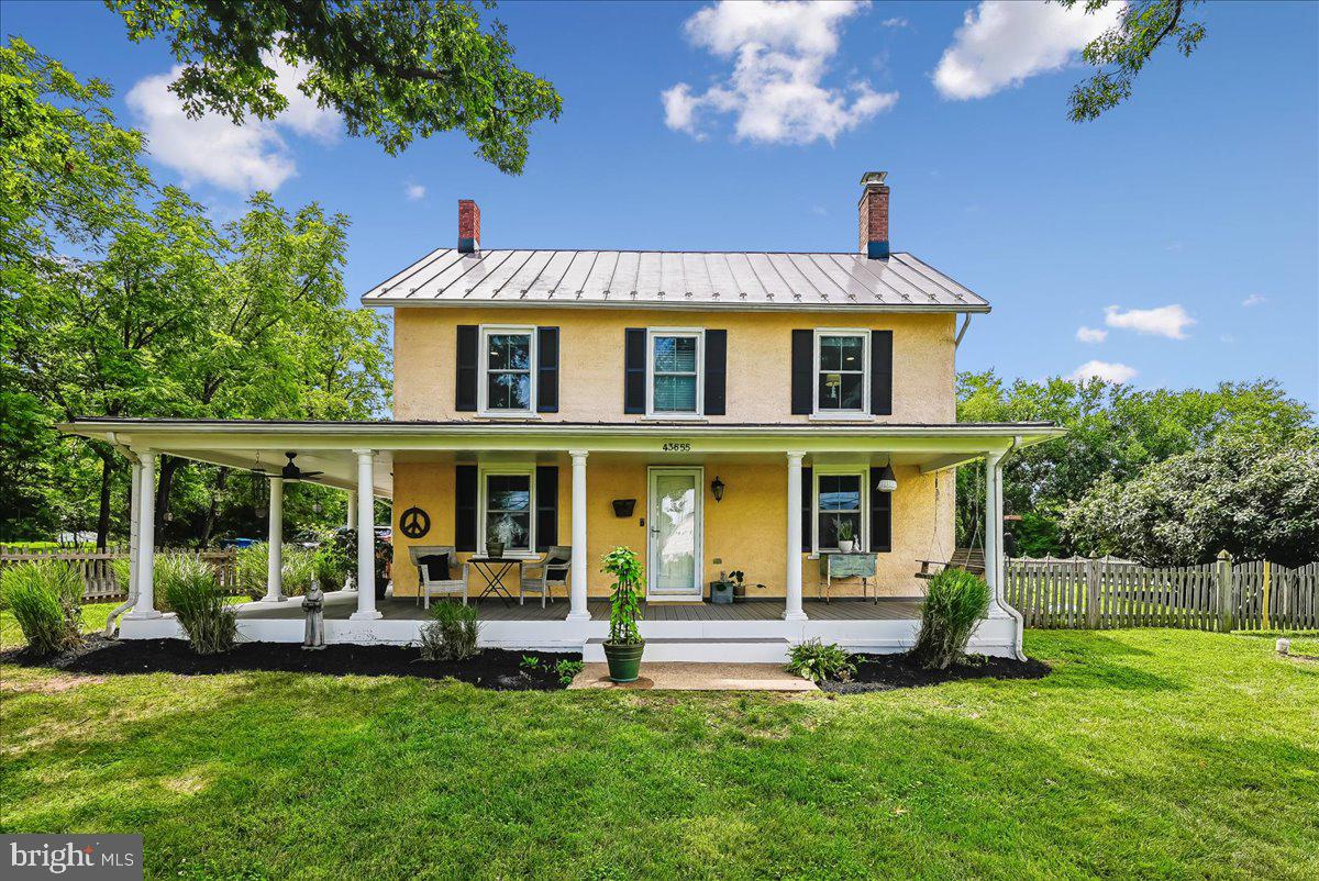 Welcome to this beautifully renovated farmhouse, originally built in 1900 and nestled in the heart of historic Old Ashburn. Blending timeless character with modern updates, this charming 4-bedroom, 1.5-bath home sits on a picturesque half-acre lot, offering exceptional space for both everyday living and entertaining.Begin your day with coffee on the refurbished wraparound front porch and step inside to discover the perfect balance of historic charm and thoughtful renovations. Hardwood floors welcome you into the formal dining room and inviting sitting/living room, featuring a brick-hearth fireplace with wood stove insert, custom paint, and battenboard accent wall. Luxury vinyl plank flooring leads into the updated kitchen, complete with a center island with quartz counter and sink, stainless steel appliances, recessed lighting, and a cozy built-in corner bench with convenient coat hooks. Step outside to the covered side porch  perfect for dining alfresco or unwinding after a long day.Just beyond the kitchen, the spacious laundry and storage area continues the LVP flooring and provides excellent functionality.   With plentiful space to utilize for a home gym, craft area, or home office.   Door access to attic storage provides more storage opportunities.  Door access to covered walkway leads to back yard.  The updated half bath showcases custom paint and classic beadboard paneling.  Hardwood floors, ceiling fan, and custom paint is featured in the spacious family room filled with natural light from windows on three sides.Hardwood stairs lead to the upper level when you'll find the private primary bedroom featuring  hardwood flooring, recessed lighting, custom paint, dual closets, and access to a charming covered side porch overlooking the serene backyard. The full bath combines vintage appeal with modern convenience, highlighted by a refurbished clawfoot tub, updated vanity, beadboard accents, custom paint, and LVP flooring.  Bedrooms 2 and 3 offers custom paint, recessed lights, and new carpeting.   The 4th bedroom offers custom paint, recessed lights, and hardwood floors.Outside, the lush, level, fenced backyard offers endless opportunities for play, gardening, gatherings, and relaxation. Additional storage is available in the outbuilding/shed.Major updates provide peace of mind, including refurbished front and side porches (2026), a new water heater and sump pump (2025); new hose hydrant (2024), new septic pump and alarm (2023); additional attic insulation, new well tank, new water softener, new UV water treatment system, new septic pump and alarm, new water heater, new front yard fence, new laundry shelf, new paint on side roofs (2022); new HVAC system (2021); new roof (2014); new windows (2013).Ideally situated in the heart of Old Ashburn (NO HOA!!), this home offers easy access to the W&OD Trail,  major commuter routes, shopping, dining, entertainment, parks, community schools, and everything Loudoun County has to offer. More than just a home, this is an opportunity to enjoy the charm, character, and lifestyle of one of Ashburn’s most beloved historic neighborhoods.  There truly is no place like home.
