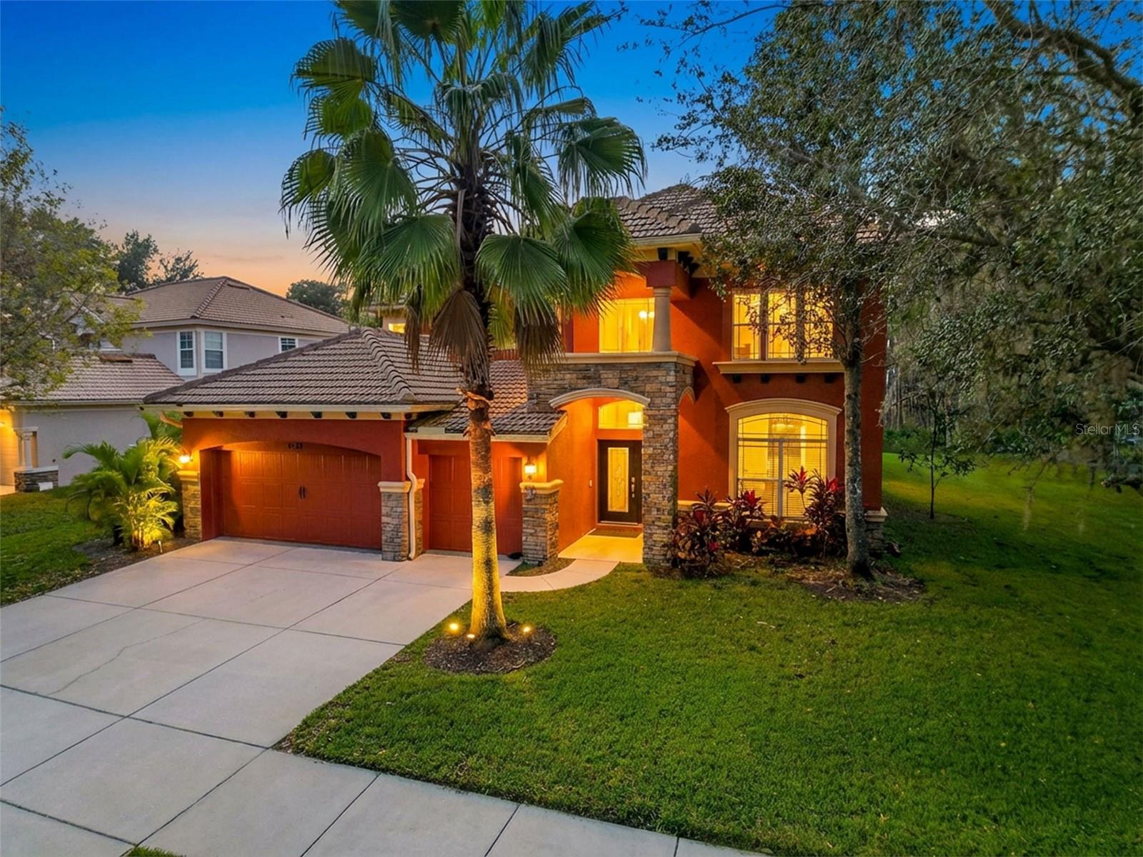 One or more photo(s) has been virtually staged. WELCOME TO YOUR SPACIOUS LAKEFRONT POOL HOME IN THE HIGHLY SOUGHT-AFTER WATERS EDGE COMMUNITY!  Situated on an oversized lot, this exceptional residence offers nearly 4,000 square feet of living space and delivers the ultimate Florida lifestyle, complete with private heated pool and spa, and exclusive private boat ramp access for lakefront homeowners. Step inside the grand, light-filled foyer where volume ceilings and an elegant curved staircase create a stunning first impression. The open-concept floor plan seamlessly connects the kitchen, breakfast nook, formal dining room, office, living room, and family room—perfect for both everyday living and entertaining.The remodeled gourmet kitchen is a chef’s dream, featuring stainless steel smart appliances, tile backsplash, premium wood cabinetry, granite countertops, pantry, center island, and breakfast bar.The first-floor primary suite is a private retreat with a sitting area, bay windows, and tray ceiling. The updated en-suite bath offers granite countertops, dual sinks, a garden tub, separate shower, and a spacious walk-in closet. The main level also includes a dedicated laundry room, office, and powder bath.The outdoor oasis, completed in 2021, is the crown jewel of the home. Enjoy year-round entertaining with a saltwater heated pool and spa, outdoor kitchen, and expansive patio—perfect for relaxing or hosting gatherings.Upstairs, you’ll find a loft and all secondary bedrooms, including two connected by a Jack-and-Jill bathroom with dual sinks. The largest upstairs bedroom has been transformed into a private movie theater, complete with in-ceiling speakers and projector.Additional upgrades include dual A/C units (2018), fresh exterior paint (2024), new sod and irrigation system (2021), and built-in theater audio (2021).Take in serene lake views as you stroll down the sidewalk to the clubhouse where your private dock and direct lake access awaits, ideal for fishing, boating, and kayaking. Lakefront owners also enjoy exclusive private boat ramp privileges.Waters Edge offers resort-style amenities, including a clubhouse, fitness center, two pools, basketball court, and two playgrounds. The low HOA fee includes cable, Spectrum high-speed internet, and trash service.This exceptional lakefront home truly offers location, luxury, and lifestyle.SCHEDULE YOUR PRIVATE SHOWING TODAY!! DON'T MISS OUT ON YOUR OPPORTUNITY TO OWN YOUR DREAM HOME!!