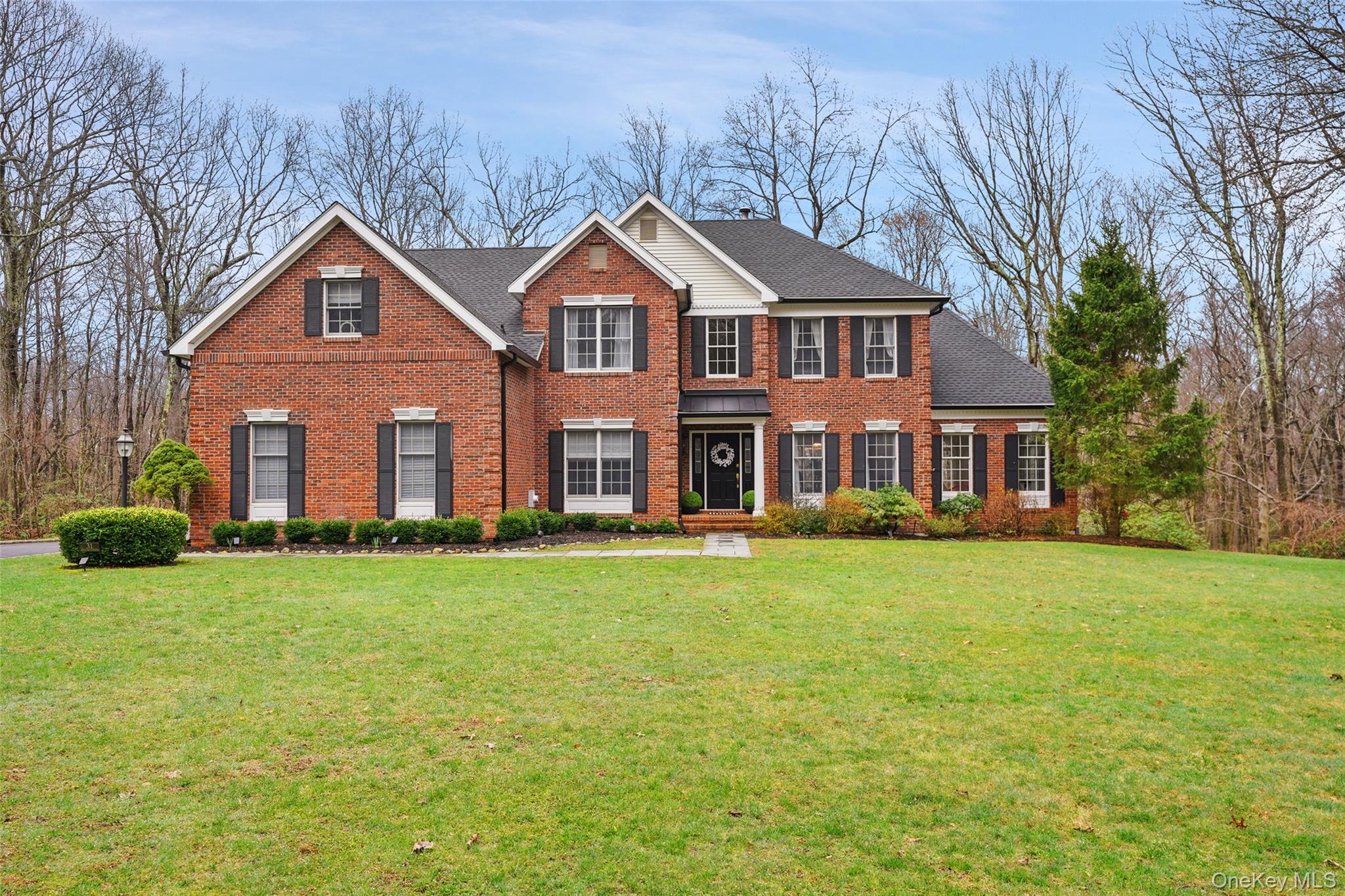 SOPHISTICATED BRICK. Stunning interior spaces with high ceilings, crisp white walls and dark wood floors. Beautifully proportioned spaces and incredible open floorplan. Dramatic Two-Story Entrance Hall. Open Living and Dining Rooms for more formal entertaining with step down to light-filled Sunroom. Fabulous new Kitchen with gorgeous Quartz counters and stainless appliances. Spacious Breakfast Area with doors to deck overlooking the dramatic Family Room with soaring ceiling and fireplace. Private Office for working remotely. Well-proportioned Primary Suite with Dressing Area and private Bath. Three additional Bedrooms. Lower level with Recreation Room. New Roof and Gutters (2025).  New Kitchen (2026).  Many new improvements.  Nearly three, landscaped acres off a quiet cul-de-sac. Established neighborhood in Katonah-Lewisboro School District. Peaceful and private, yet moments from the shops of Vista, Ridgefield and New Canaan. Easy access to Routes 123 and 35, the Merritt Parkway and Metro-North trains. Fabulous!