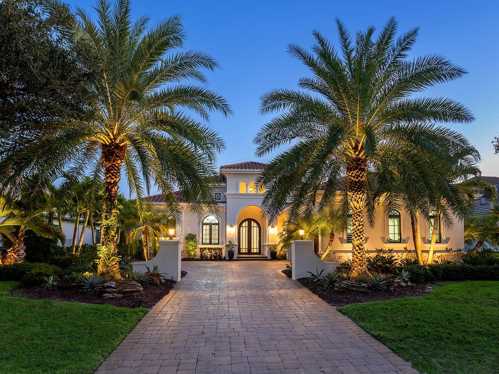 Under contract-accepting backup offers. Welcome to 16218 Daysailor Trail, an exceptional estate residence set behind the gates of The Lake Club at Lakewood Ranch. Built in 2018 and meticulously maintained, this nearly 3,100-square-foot, single-level home embodies refined Florida living, offering expansive unobstructed long lake views and desired southern exposure that provides a tranquil, ever-changing natural backdrop. Positioned on a premier waterfront homesite, the property features over $57,000 in recent upgrades and a thoughtfully curated selection of upscale finishes throughout. Enter through the double glass and iron doors into a bright, timeless interior where the expansive great room impresses with high-volume ceilings accented by wood beams, rich hardwood flooring, a gas fireplace, and pocketing impact-glass sliders that seamlessly blend indoor and outdoor living. The outdoor living space is equally compelling, offering generous covered lounge and dining areas, a fully equipped outdoor kitchen, and a heated saltwater pool and spa, all overlooking private lake views designed for year-round enjoyment. At the heart of the home, the chef’s kitchen is a showpiece, offering double-stacked wood cabinetry with glass-front uppers, lighted interiors and slide-out shelving. Premium appliances include a Wolf gas cooktop, wall oven and microwave, Sub-Zero built-in refrigerator, Miele dishwasher and a walk-in pantry with custom shelving. Calacatta Lazza quartz countertops, a stacked herringbone backsplash, farmhouse sink and elegant pendant lighting complete the island, which doubles as a breakfast bar and flows seamlessly into the dining area. The dining room, with corner sliding glass doors and serene water views, is an entertainer’s dream. The private primary suite offers a peaceful retreat with French doors flowing to the lanai, two spacious walk-in closets with custom built-ins, and a spa-inspired bath featuring split vanities, a large walk-in shower and a soaking tub. Two additional en-suite bedrooms provide comfort and privacy for family and guests. A versatile bonus room, used as a fourth en-suite bedroom with hardwood flooring, adds flexibility to the floor plan. The den, ideal for a home office, features wood flooring, plantation shutters and pocketing glass French doors, creating a quiet space for work or relaxation. Additional highlights include professionally designed landscaping with accent lighting, Italian plumbing fixtures, plantation shutters throughout and custom window treatments, central vacuum with kitchen kick sweep, solid-core interior doors, crown molding, 7¼-inch baseboards, whole-house surge protection, a newer pool heater, recently painted exterior, Honeywell Wi-Fi thermostats, replacement of all pool screen frame bolts and a three-car garage with EV charging station. A discreet side-yard dog run with turf completes the thoughtful design. Meticulously cared for and move-in ready, this exceptional home delivers a balance of elegance, comfort and effortless luxury. The Lake Club is a gated community anchored by an impressive 20,000-square-foot clubhouse offering a collection of luxury amenities. Residents enjoy two resort-style pools, including a zero-entry pool with a splash park, poolside dining, a full-service spa and a state-of-the-art fitness center, tennis and pickleball courts with professional racquet staff cater to sports enthusiasts, and an active social calendar keeps the community connected year-round. Total tax amount includes CDD fee.