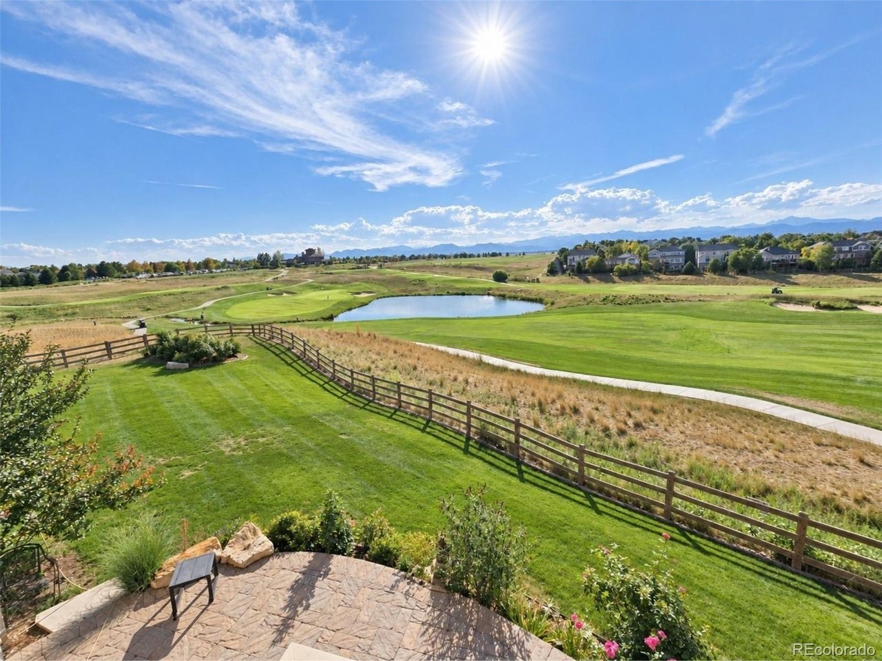 BREATHTAKING PANORAMIC VIEWS from the 18th fairway of Colorado National Golf Course! Rarely does a home like this come available. Perched on one of Vista Ridge's most coveted lots, this like new home delivers unobstructed 180 views of the Front Range, the 18th fairway and greens on Colorado National Golf Course. Front-row seats to legendary Colorado sunsets, hot air balloons, and fireworks from the primary suite, living room, main floor balcony, walkout basement patio/hot tub/firepit, and bedrooms. 4,214 sq ft of thoughtfully designed living space blends low-maintenance ranch-style ease with the flexibility of a 2-story layout - including a private study behind glass French doors and a guest suite. A custom iron staircase with hardwood treads sets an elegant tone at the entrance. The gourmet kitchen with huge granite island, upgraded cabinetry, and stainless appliances, connected via butler's pantry to the formal dining room - perfect for entertaining. The 2-story family room, anchored by a cozy fireplace, frames those million-dollar views in every direction.Wake up to mountain views in the main-floor primary, complete with a spa-inspired bath, open shower, and walk-in closets.The walkout basement has been updated recently and features all-new hardwood flooring, a custom wine cellar, and a private gym, a guest retreat wtih private en-suite, and a pool table and full bar for entertaining. Step outside to a brand-new paver patio with fire pit, an outdoor kitchen with gas grill, and a hot tub, all set against freshly enhanced landscaping designed to showcase those unbeatable 180 views.PLEASE REACH OUT TO LISTING AGENT FOR A PRIVATE SHOWING.