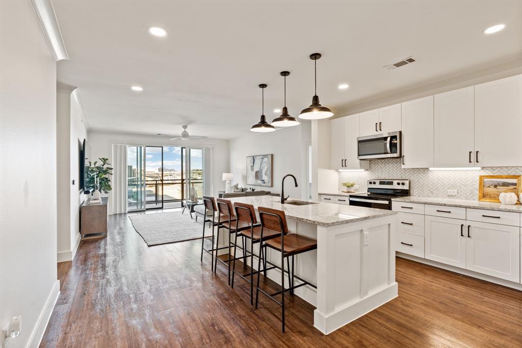 Ideally positioned in Lewisville just minutes from Grandscape, this upgraded corner-unit condo offers a refined blend of modern style, comfort, and convenience. Thoughtfully enhanced with multiple upgrades, the home features an open-concept layout filled with natural light, creating a bright and inviting atmosphere throughout. The kitchen is both functional and stylish, showcasing a spacious island, contemporary finishes, and modern appliances—perfect for entertaining or casual everyday living. The living area flows effortlessly to a private balcony, providing a relaxing outdoor space to enjoy morning coffee or evening downtime. The primary suite serves as a comfortable retreat with ample space for a king-size bed, a sleek en-suite bathroom, and a generous walk-in closet. Two additional bedrooms offer flexibility for guests, a home office, or fitness space, with convenient access to a well-appointed secondary bathroom.Notable highlights include two designated parking spaces—one covered garage space and one assigned exterior space—along with a dedicated storage unit for added convenience. Located near major highways, including the Sam Rayburn Tollway, this corner-unit condo delivers upgraded living in close proximity to premier shopping, dining, and entertainment, all within one of Lewisville’s most desirable communities.For Open Houses: Building access required — please contact agent upon arrival.
