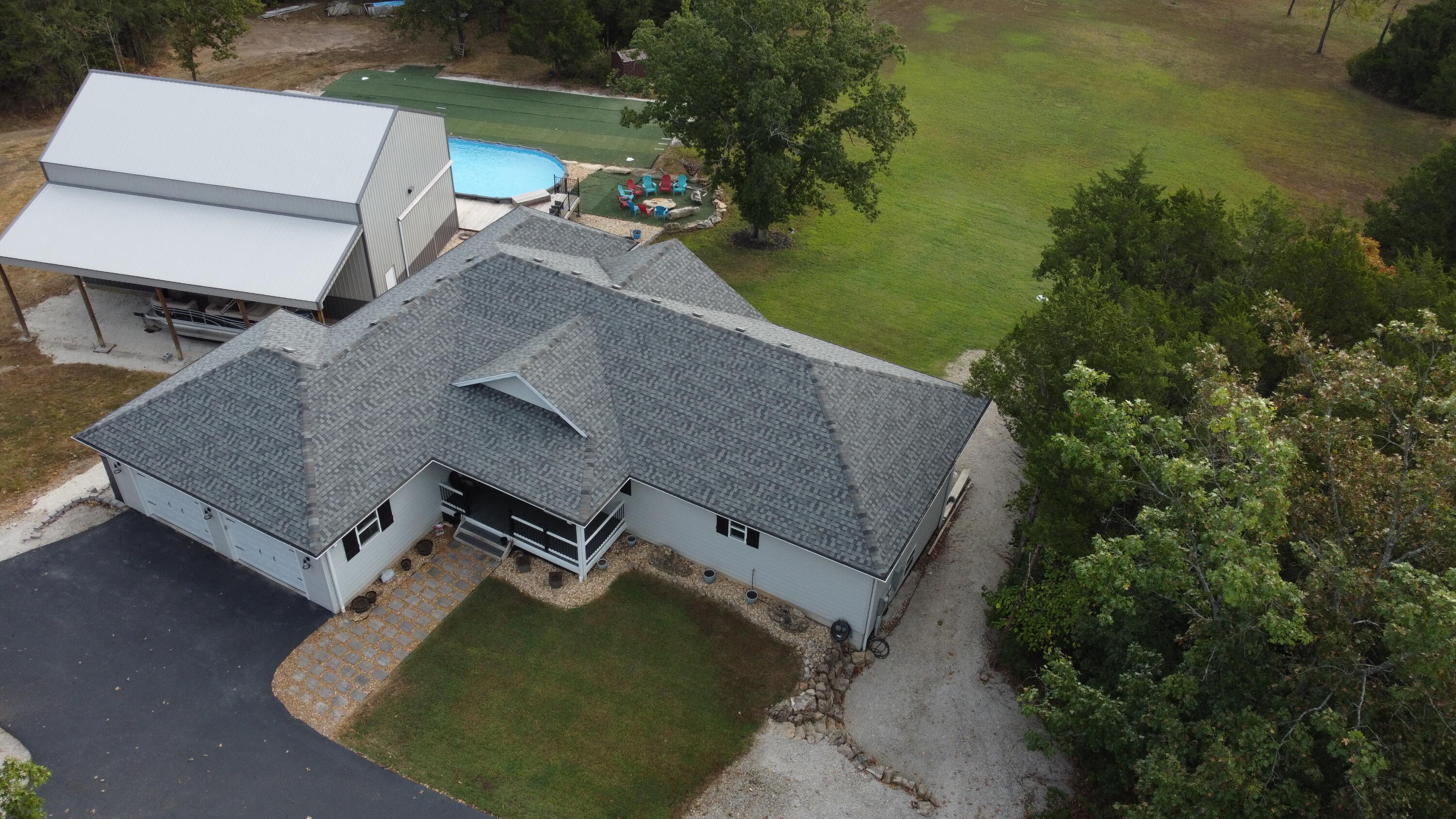 Stunning 10-Acre Estate Just Minutes from Branson!Enjoy the perfect blend of privacy, luxury, and convenience in this beautiful 3-bedroom, 3-bathroom home. Nestled on 10 pristine acres just 8 miles north of Branson, this property offers a peaceful country retreat with excellent, immediate access to Hwy 65.Spanning approximately 3,500 square feet, this meticulously designed home features exceptional indoor and outdoor living spaces.Main Level EleganceOpen-Concept Core: A spacious, sunlit Living-Kitchen area forms the heart of the home, complemented by a separate formal dining room perfect for hosting.Master Suite Sanctuary: The main-floor master bedroom is a true getaway. The spa-like master bath boasts split vanities, a large walk-in shower, a freestanding soaking tub, and expansive his-and-her walk-in closets.Daily Conveniences: A highly functional mudroom just off the garage keeps transitions seamless and a serene screened-in porch sits just off the dining room.Ultimate Walkout BasementFamily & Guest Space: The massive downstairs family room offers the perfect separation between two additional large bedrooms--each featuring its own walk-in closet and full bath.Smart Storage: Includes a large dedicated storage area and a functional John Deere room to efficiently utilize every inch of the walkout basement.Premium Outbuildings & Toy StorageAttached Garage: Spacious 2-car garage for daily drivers.The Shop: A massive 28' x 14' shop featuring towering 20-foot sidewalls and a full-length lean-to, providing unparalleled space for your boats, RVs, tractors, and toys.Resort-Style Backyard OasisAfter a peaceful walk through your private 10 acres watching the deer and turkeys, step into an outdoor entertainment paradise. Relax by your private swimming pool, unwind on the expansive decks and patios, or watch the kids and pets play in the low-maintenance artificial turf play area.
