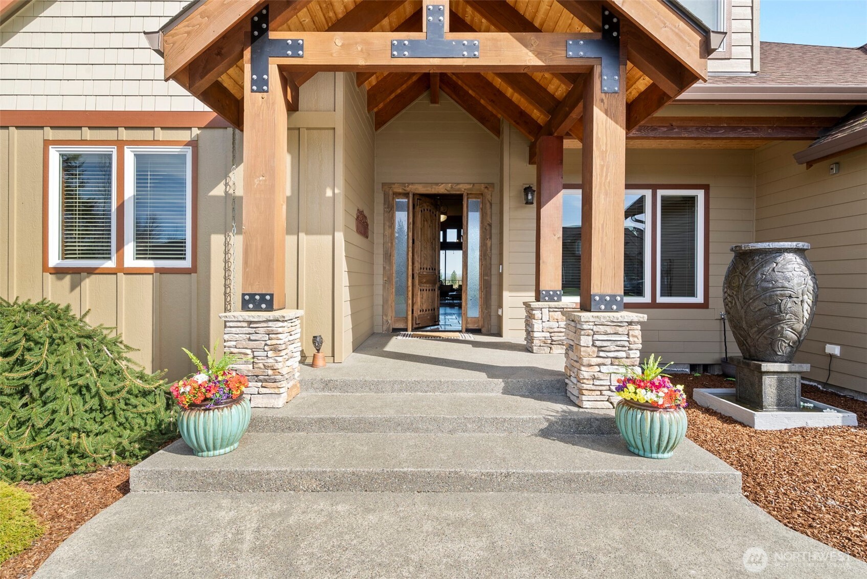 Set across 4.2+/- acres, this 4,015+/- sq ft residence captures a sense of space, light, and quiet that’s increasingly hard to find. Territorial views stretch outward, with partial mountain views beyond, while each morning begins with a truly breathtaking sunrise—best experienced from the home’s expansive wraparound deck. Inside, the materials speak for themselves. Hickory floors, a chiseled travertine entry, and knotty alder trim create a natural, grounded palette that carries throughout. The chef's kitchen is designed for both presence and performance—granite surfaces, a gas range with pot filler, double ovens, and soft under-cabinet lighting that shifts the space effortlessly into evening. Twelve-foot doors open wide to over 1,100+/- sq ft of covered, wraparound composite decking, blurring the line between indoors and out. The layout offers both scale and flexibility, with 3 bedrooms and 3 bathrooms, along with a bonus room, office, and dedicated workout space. The primary suite is set apart as a place to unwind, featuring a soaking tub, dual-head walk-in shower, and a spacious walk-in closet with built-ins. Beyond the home, a 3-car garage is complemented by a fully insulated 36x50 shop with oversized doors, while a second shop—over 1,700+/- sq ft with utilities stubbed—opens the door to future possibilities, whether for extended living, workspace, or something more.