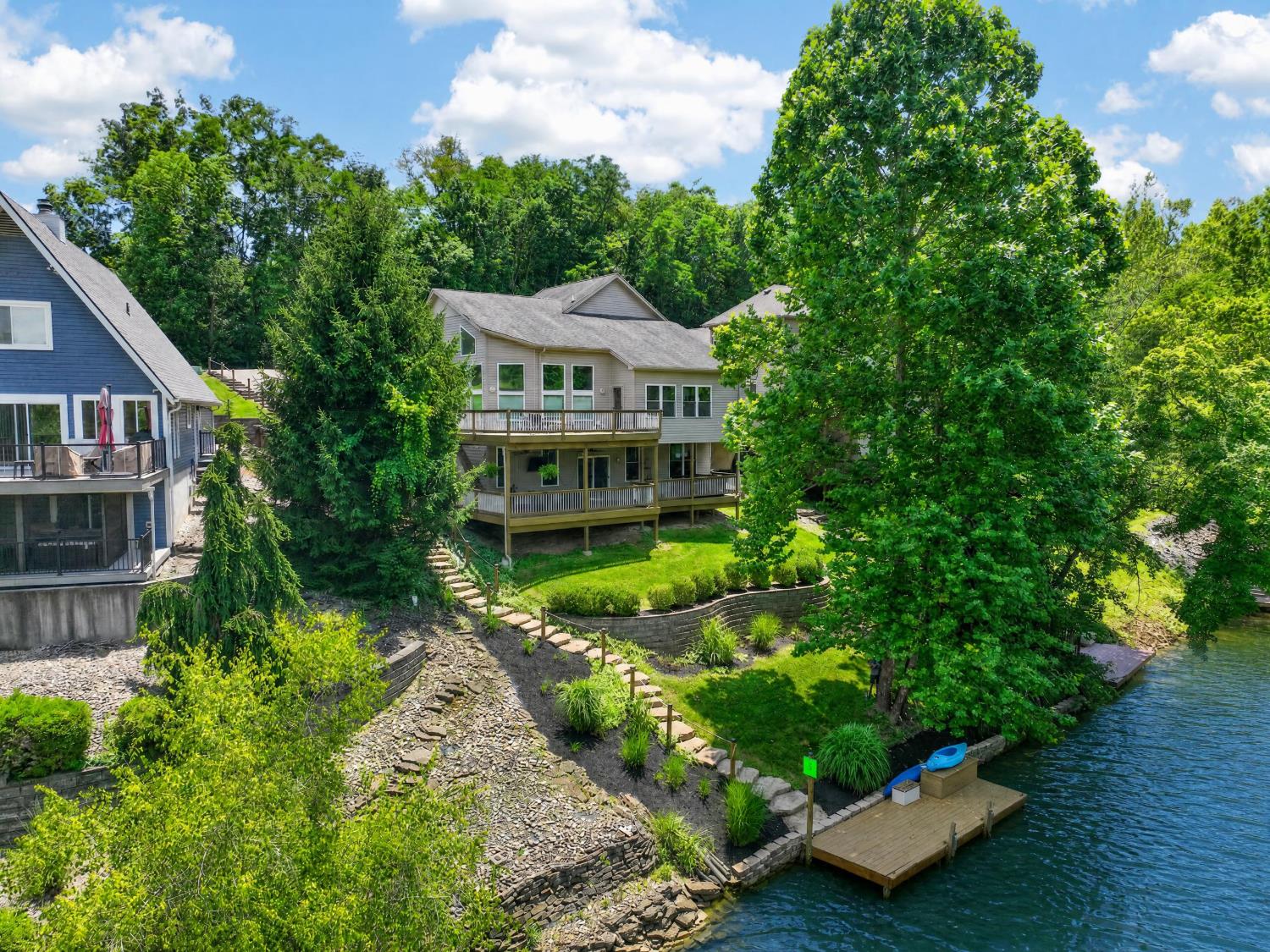 Stunning Lakefront home on Hidden Valley Lake! Walls of windows & sprawling wrap around decks to enjoy the lake views from all levels. Enjoy your own private dock for fishing & your boat. Stone steps, paver walls and wood dock already in place. Cathedral ceilings adjoin the Living room & kitchen with a double sided floor to ceiling stone fireplace and wood floors. A large kitchen island for entertaining, ss appliances, built in desk, fireplace, pantry & door to deck for easy grilling and outdoor dining. Main floor Master Bedroom retreat and Laundry room. The second floor offers a lg. loft living space or office, 2nd master suite and full bath. The lower level is finished with 9ft. ceilings, thru body porcelain tile flooring, wet bar, full bath and two guest rooms. There is plenty of room for using this space for extended guests or an In-Law suite. The area opens to the lower deck, featuring a Jacuzzi Hot tub & seating location for watching tv. Close to Golf Course!