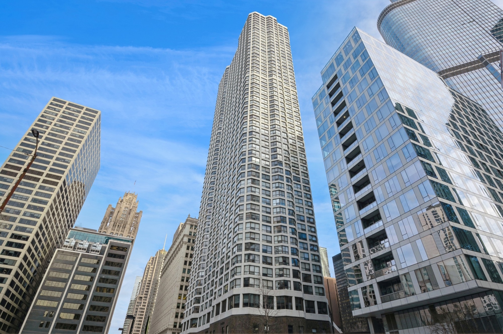 Spacious north facing unit with wonderful skyline views. BRAND NEW MODERN hardwood flooring throughout! Gorgeous light color. FRESHLY PAINTED a soft light gray throughout as well. The space feels much larger than its 890 SF footprint. Good closet space. So much storage space, rare for the area and additional storage locker and built-in safe included! Enjoy the best of urban living in this full amenity property ideally located in the heart of popular River North. Building also includes business center, cleaners, beauty salon and restaurant. Steps from the amazing Chicago River Walk, a block away from Michigan Ave shopping, dining and a few minute Uber to the lakefront. Parking available to rent/buy in building. HOA includes heat, A/C, water, heated pool, huge exercise facility, cable/internet and more. Easy to show.
