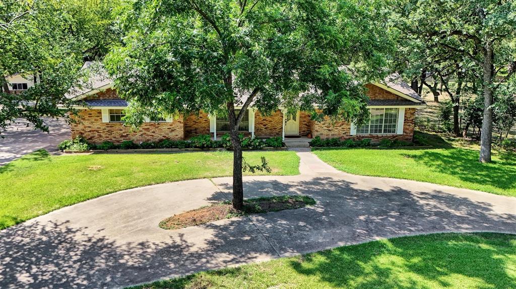 Country in the city!  Bring your horses!  Your dream country home is waiting! This unique 2.84 acre wooded property is located in Irving within close proximity to DFW International Airport with easy access to Airport Freeway and other major highways.  The 2146 sq-ft home sets on a quiet circle within the City of Irving.  It has 3 bedrooms, 2 full baths and 1 half bath; two-car attached garage. The spacious kitchen with breakfast nook adjoins the family room with a large brick fireplace.  It has a formal dining area and additional living area combined.  The patio looks out upon large Texas oaks in the back yard.  Plenty of room for relaxing or entertaining.  Behind the house sets a 1200 sq ft, 3 car garage with finished interior.  This building could easily be converted into a family party area or office space with single car garage and kitchen.  Next door to this building is a very nice 1792 sq-ft workshop or storage building, whichever you choose, also with a garage door entry. Additional highlights of this property include easy access driveways, oversized windows throughout the home, sprinkler system, irrigated garden area, as well as other storage units on the property, energy efficient home, lots of cabinetry throughout the house, and the best neighbors you could ask for.  Horses are permitted on this property as well as all the chickens you want.  All of this is just minutes from major highways, shopping, dining, and everyday conveniences.
In addition to this property, the 2.29 acre lot next door is owned by the same family.  It  has a 2 bedroom, 2 bath home and will also be offered for sale in the near future.