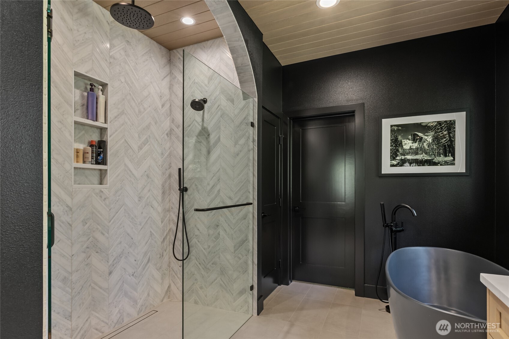 Custom Tile Shower with Rain head and soaking tub that leads to a nice walk in closet.