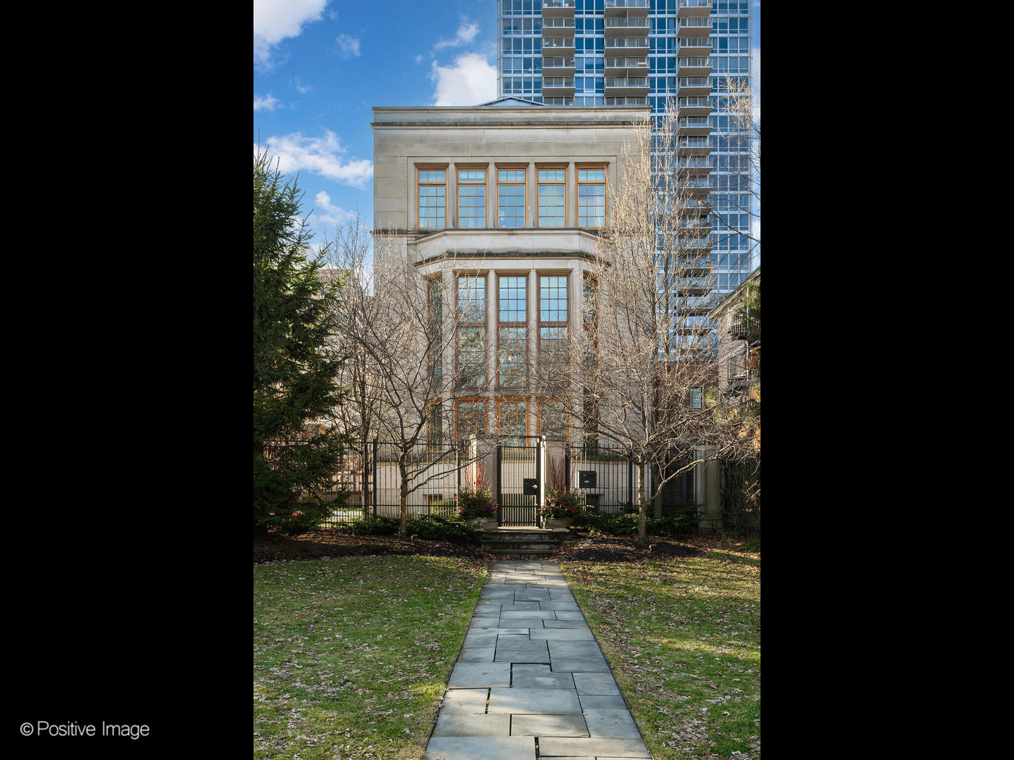 Rare opportunity to own an impeccably maintained single-family residence on Lake Shore Drive, situated on an expansive 34' x 134' lot with approximately 9,000 square feet under roof. This exceptional home offers 7 bedrooms and 7.5 baths and features multiple outdoor living spaces, with 30' x 20' garage rooftop terrace with a custom outdoor kitchen-ideal for entertaining. A dramatic foyer welcomes you into the main level, which features a gourmet kitchen, great room, and a striking living area with soaring 20+ foot ceilings, a gas fireplace, and a dining space overlooking Lake Shore Drive. The kitchen is appointed with custom white cabinetry, natural stone countertops, professional-grade appliances, a dedicated coffee and beverage nook, and a built-in breakfast banquette.  A striking custom double staircase connects the upper levels. The second-floor features three light-filled ensuite bedrooms with custom-built-in storage. The third floor is home to a refined primary suite with custom millwork, a fireplace, and a tucked-away sitting area. The spa-inspired primary bath features an oversized rain and steam shower, a soaking tub, dual vanities with Calacatta marble countertops, and heated marble floors. A spacious dressing room features a center island. An additional ensuite bedroom and a laundry room complete this level. The top floor showcases exceptional custom woodwork and offers a large bar and entertainment lounge, a half bath, a workout room, and two rooftop decks with open views. The lower level includes a family/media room, wet bar, full bath, an ensuite bedroom, ample storage, oversized refrigerator and freezer capacity, and a mudroom with direct access to the 3-car garage. Additional highlights include a Control4 audio system, an elevator, individual HVAC zones, a security system, an irrigation system, and outdoor snow-melt. You have secure private alley access to a 3-car attached garage.