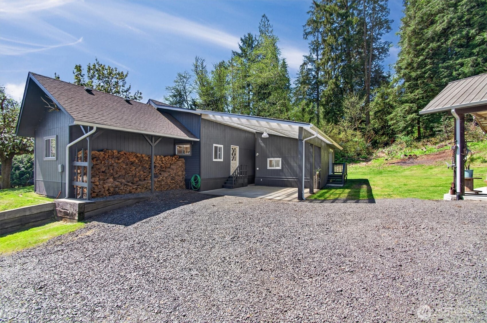 Tucked away in the woods, this serene country compound is a dream for those who love space, nature, and versatility. The park-like grounds invite you to relax around the firepit or explore the neighboring public land right from your doorstep. Sip your morning coffee on the deck while taking in peaceful valley views and watching local wildlife, including eagles, deer, and elk. Inside, enjoy three main-level bedrooms plus a flexible loft space ideal for guests, a home office, or a rec room. The impressive 24x36 three-bay shop and separate workshop with wood stove and covered patio provide endless opportunities for hobbies, storage, or workspace. With 0.8 acres, southern sun exposure for gardening, covered RV parking, woodsheds, and multiple covered parking options, this property is built for both comfort and adventure. Take a 10 minute drive to access the Columbia River for fishing or recreation. Centrally located, you’re just 1.5 hours to Portland and only an hour to the coast—making it easy to enjoy the best of both worlds while coming home to your own peaceful retreat. This is the one!