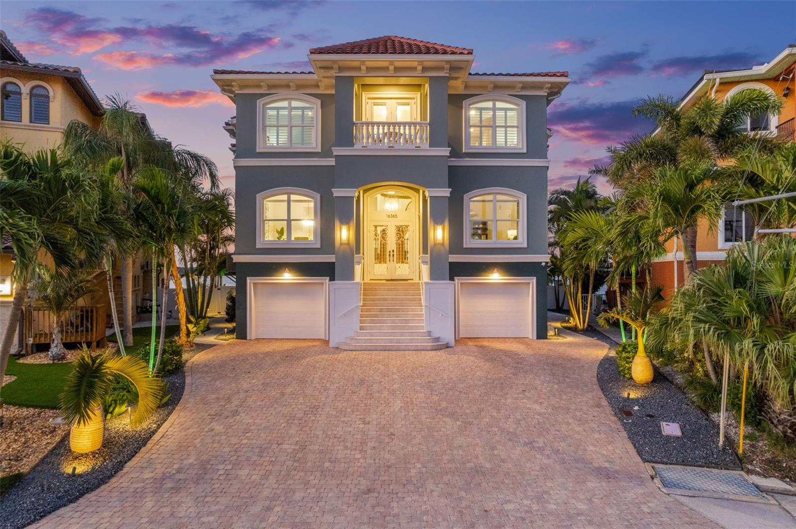 SOON TO BE FEATURED ON HGTV'S 100 DAY DREAM HOME! RARE COVETED POINT LOT ON THE INTRACOASTAL WITH OPEN WATER VIEWS!!! This extraordinary ELEVATED estate is a sanctuary of style, technology, AND strength, offering the ultimate expression of refined waterfront living!  Every detail of this home has been meticulously reimagined- TONS OF RECENT RENOVATIONS including new interior and exterior paint, premium porcelain tile flooring, upgraded bathrooms, upgraded chef's kitchen, automated privacy sunshades, pavers, landscaping, and more.  With an unrivaled commitment to structural integrity, this residence is engineered to withstand the fiercest storms, built with insulated concrete construction, a tile roof, impact-rated windows, triple-lock doors, and a 2025 generator.Distinguishing features that elevate this home above the rest include a commercial-grade elevator servicing all levels, a full-home Control4 smart automation system, integrated stereo sound throughout, and the convenience of natural gas. Behind the front door lies a grand foyer that sets the tone for what’s to come: soaring ceilings and seamless flow between curated living spaces. The sophisticated office, formal dining room, and open-concept family room are bathed in natural light with stunning water views. The designer kitchen is a statement in itself—anchored by a dramatic, extra-thick quartz island and outfitted with top-tier appliances, ideal for culinary artistry and entertaining. Enjoy seamless indoor-outdoor living with balconies on both the front and back of the home—perfect for sunset dinners while watching the boats pass, or unwinding in complete tranquility—this is a setting like no other.Upstairs, retreat to your private primary suite—an opulent haven with its own gas fireplace,  private balcony offering uninterrupted water views, and spa-inspired bathroom featuring a soaking tub, resort-style shower, and exceptional walk-in closet system.  Spacious guest suites with en-suite bathrooms provide comfort and privacy. Outdoors, enjoy a newly resurfaced saltwater pool with brand-new pump and equipment, a putting green, and multiple spaces to unwind or entertain. The dock and boat lift have been professionally maintained and recently descaled, offering direct access to the Bay for effortless boating. A transferable flood insurance policy with premiums under $1,000 annually adds an extra layer of value and peace of mind. Located minutes from pristine beaches, bars, restaurants, and shopping, this property sits in a golf cart-friendly community—this is not just a residence, but a lifestyle. Don't miss out on your opportunity to own one of the most exceptional waterfront properties on the market today!