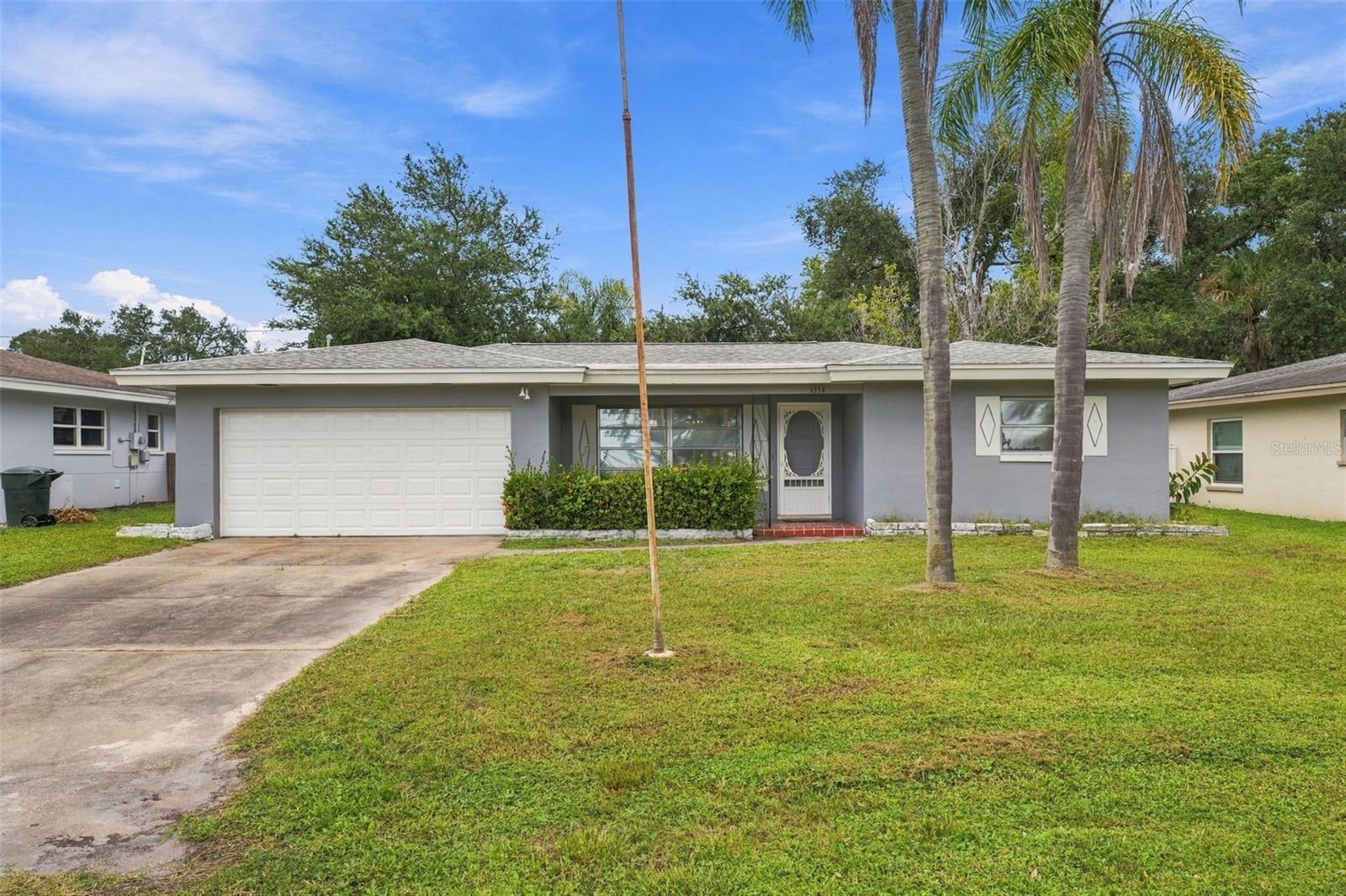This may be the best value in Dunedin: a single-family house on its own lot for under $350,000, with 2 bedrooms plus a bonus room (possible third bedroom, guest room, office or Florida room), 2 full baths, an attached 2-car garage and 1,432 sq ft under air, bonus room included. No HOA. No CDD. Flood Zone X. No known sinkhole issues. At the time of listing, no other single-family home for sale in Dunedin offers all of that under $350,000. Smaller Dunedin homes with a carport or no garage are listed for more.The money went where it counts: supply lines repiped in 2020, roof replaced in December 2015, fresh exterior paint in 2025 and fresh interior paint in 2026, kitchen cabinets included. Washer and dryer are included, the yard is fenced, and the garage fits a car and a golf cart with room to spare.You are a mile and a half from downtown Dunedin, with the Pinellas Trail, the Dunedin Causeway and Honeymoon Island a short drive away. Move in and enjoy the Dunedin charm as it is, or make it your own over time.