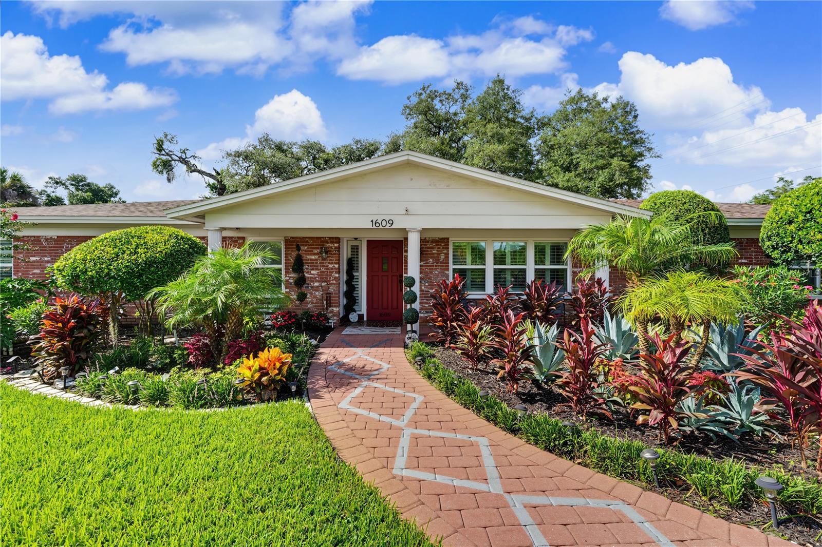 Step into the timeless charm of this 1960s ranch, offering the perfect opportunity to create your dream home. This 4-bedroom, 3-bath home is situated on an oversized corner lot in a non-HOA community. This home has been well-maintained with a new water heater and new electrical panel in 2025, all new windows and plantation shutters in 2022, a new garage door in 2021, and new roof and air conditioner in 2019.  This charming brick residence offers 2,245 square feet of warm and inviting living space.  All four bedrooms are generously sized, including a primary with an ensuite and walk in closet. Step outside to the oversized 24x12 patio and 2/3 fenced back yard, perfect for outdoor activities. Inside, tasteful wood, ceramic tile, and terrazzo floors create character throughout the home.  Conveniently located near top-rated schools, shopping, dining, I-75, and just 30 minutes to Tampa International Airport and MacDill AFB, this move-in ready home offers comfort, space, and convenience in an ideal Brandon location.
