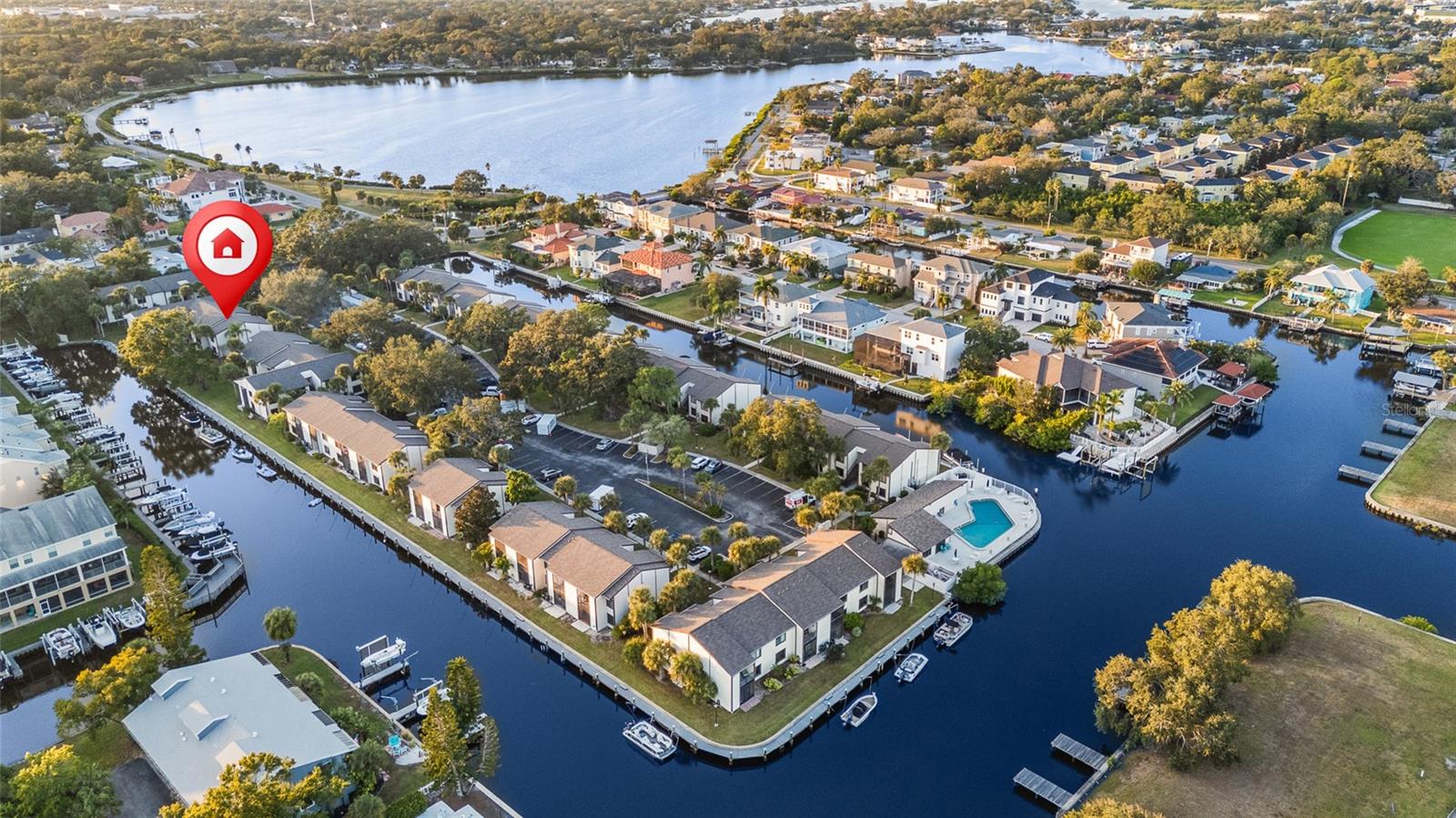 Waterfront Living. Gulf Access. Sunsets from Your Balcony. This isn’t just a condo, it’s Florida living at its best. Perched on the top-floor corner with no one above you, this 1,210 sq ft 3-bedroom, 2-bath home enjoys soft breezes, natural light, and peaceful canal views from the living room, kitchen, and primary bedroom. Watch the water shimmer with your morning coffee and listen to the palms sway in the evening. It’s calm. It’s coastal. And it’s move-in ready. Inside, the layout simply works, an open living and dining area flowing into a well-appointed kitchen with marble countertops, new refrigerator, recently updated appliances, a deep stainless farmhouse sink and stackable washer & dryer. The primary bedroom features canal views and its own ensuite bath with a dual vanity, while bedroom 2 connects to a Jack-and-Jill bathroom that also opens to the hallway for guest access. Bedroom 3 sits just down the hall. Updated laminate flooring and baths, a screened balcony, a newer roof, and a brand-new HVAC system (July 2025) make day-one living easy. And importantly,  this unit did not flood during the 2024 hurricanes. Step outside to your private screened balcony and take in views of the canal that leads out to the Gulf. If you love the water, bring your boat! Slips are first-come, first-served, with no additional fee, and typically available. From the dock, it’s a lovely cruise to open Gulf waters. The community is all-ages and pet-friendly, offering relaxed waterfront amenities like a heated pool overlooking the water, clubhouse, dock and boardwalk, kayak launch, picnic gazebo, and storage for kayaks, canoes, and bikes. And the HOA takes care of the big stuff; flood insurance, water, sewer, trash, cable, Wi-Fi, roof, exterior maintenance, landscaping, pool care, and boat docking. And the location? Hard to beat. You’re just minutes from downtown Tarpon Springs, the Sponge Docks, authentic Greek restaurants, Fred Howard Park, Sunset Beach, medical facilities, golf courses, and the Pinellas Trail. This is a town where sunsets, seafood, dolphins, and festivals are part of everyday life. Whether you’re searching for a seasonal getaway or a full-time coastal home, this condo makes waterfront living easy, comfortable, and within reach. Come see it,  you’ll feel it the moment you step inside.