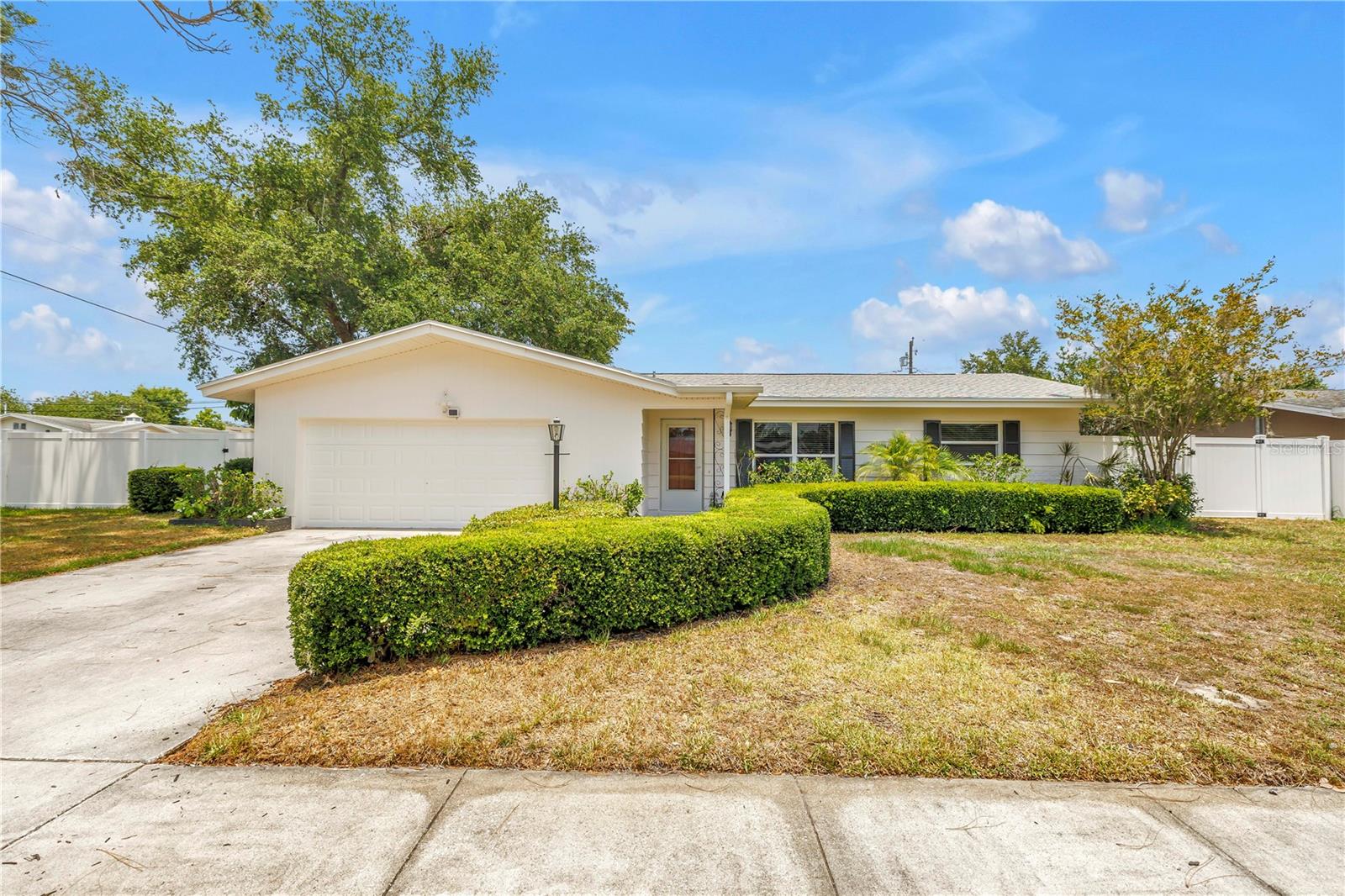One or more photo(s) has been virtually staged. Welcome Home to a beautifully situated residence offering the perfect blend of comfort, convenience, and Florida charm. This 4-bedroom, 2-bathroom home has been freshly painted inside and out and features a desirable split floorplan, offering privacy and functionality for both homeowners and guests, and sits on a spacious corner lot that adds extra curb appeal and room to enjoy. This home welcomes you with a warm, light-filled interior with an open concept layout designed for both everyday living and effortless entertaining. Step outside to your own private oasis, complete with a sparkling pool and irrigation system to help maintain the lush landscaping year-round. From its spacious living areas to its serene outdoor setting, every detail invites you to relax and feel at home. Just minutes from stunning Gulf beaches, local dining, shopping, and parks, this property delivers the lifestyle you?ve been looking for?whether as a primary residence, seasonal retreat, or investment opportunity.