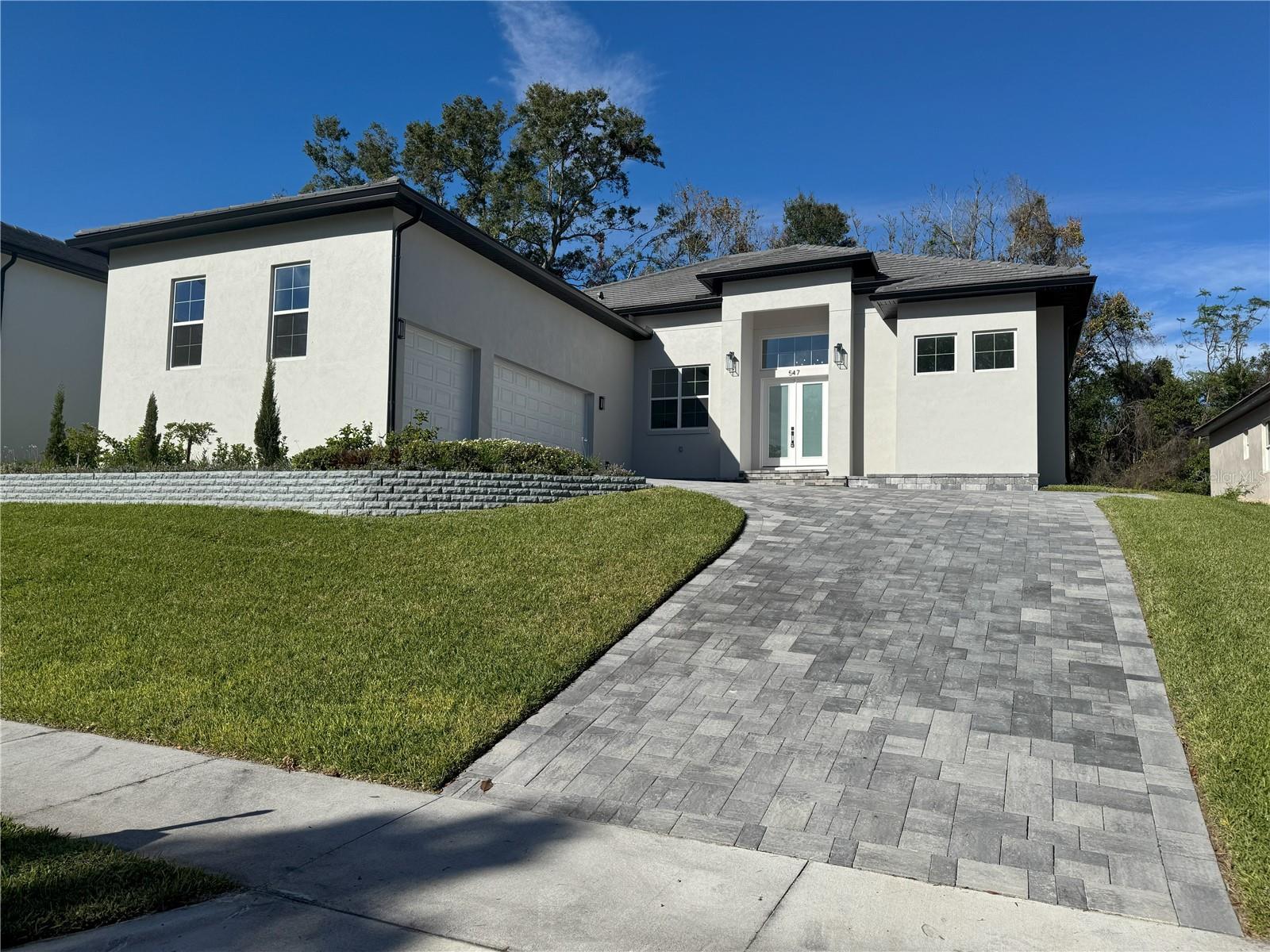 NEW CONSTRUCTION!!! Located in an exclusive, gated custom home community. This gorgeous, modern, and open-concept home has a huge list of upgrades. The list includes a 30 year flat tile roof, paver driveway, high tray ceilings in the common areas and primary bedroom, 7 inch baseboards, a waterfall kitchen island with farmhouse sink, shaker cabinets with crown molding, dual ovens with a combo microwave, three-car garage, vented range hood, gutters with underground drainage, wired cat 6 network as well as a dedicated office for those working from home, built in closets, and fully upgraded primary bath. The primary bath has a free standing soaking tub, upgraded ceramic tile floors and shower walls, separate vanities with plenty of cabinet space, upgraded ceramic tiles throughout the common spaces with plush carpets in the bedrooms. This is your chance to be the first resident of this exceptional property that perfectly blends style, comfort, and functionality. Schedule a viewing today and step into your new life in this stunning home!