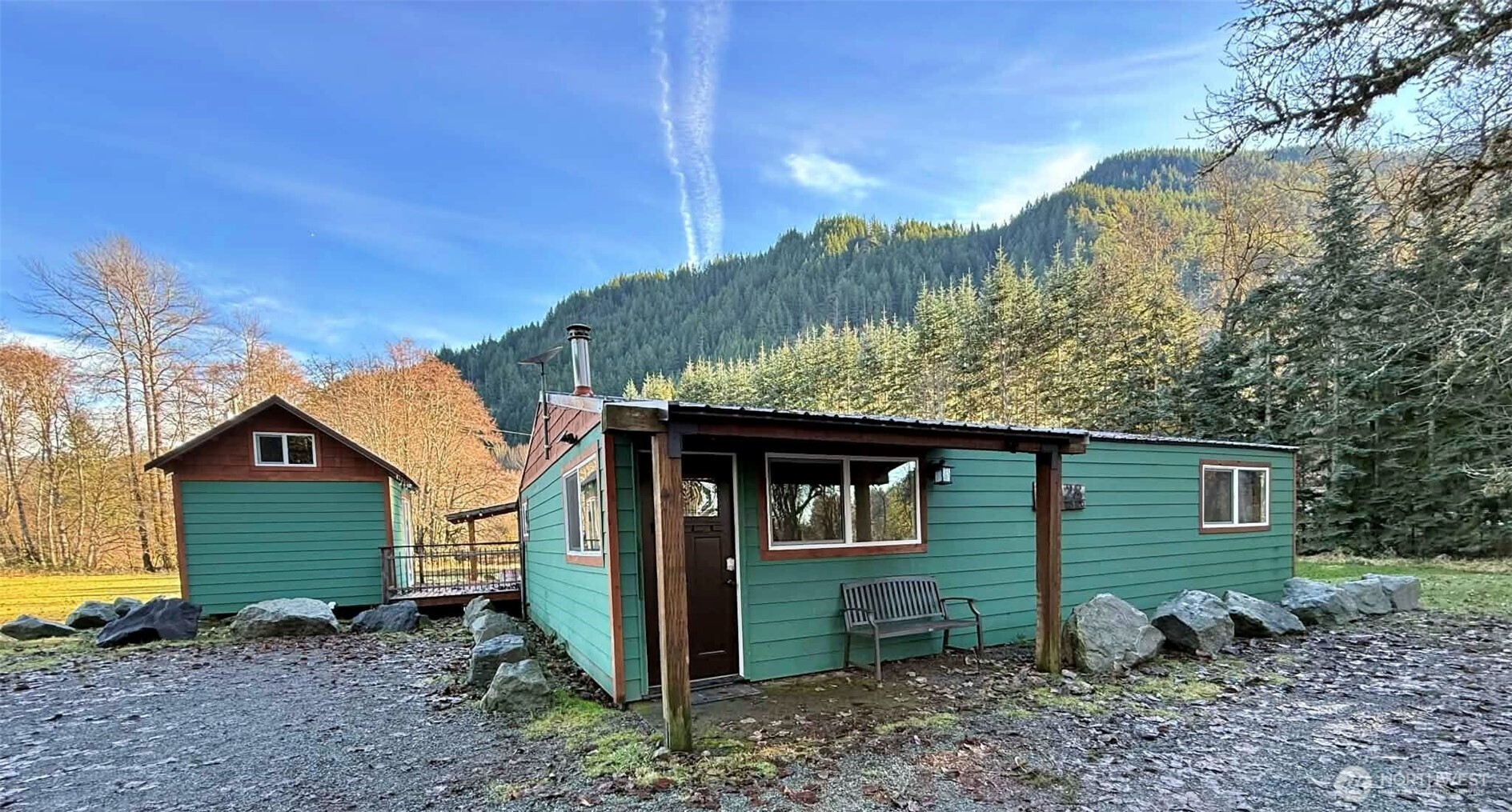Come check out this cozy cabin about 30 minutes from White Pass. Currently used as an STR featured on sites such as Airbnb and VRBO, you can use the property as your full-time home or continue to utilize it as an income-producing residence and stay when you feel like escaping to your own quiet retreat. Although the home is close to the highway, there is plenty of foliage to block it from view, and you can't hear road noise from inside the home. Situated on 2.4 acres, the main cabin features a warm, rustic design with 1 bedroom and 3/4 bath. The bunk house offers a queen-size bunk bed, and situated between the two is a spacious deck perfect for entertaining, and a cedar soaking tub.