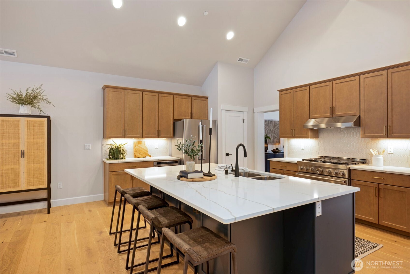 A large center island anchors the kitchen, offering abundant extra storage and comfortable seating for six—perfect for casual meals, entertaining, and gathering with family and friends.