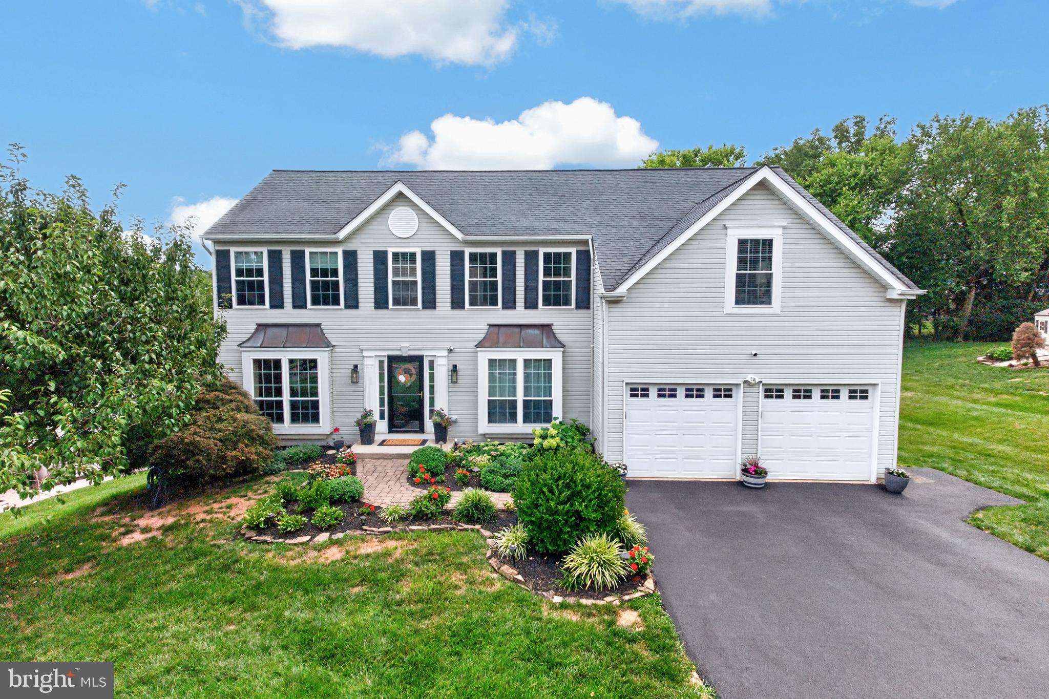 Welcome to this exceptional 4-bedroom, 2.5-bath home in the highly sought-after Riverwalk community in Phoenixville. Impeccably maintained throughout, this is a home where quality craftsmanship and timeless style come together.  A paver walkway, extensive landscaping, landscape lighting, front-yard sprinkler system (2021), and a resurfaced/ sealed driveway (2025) create outstanding curb appeal and a memorable first impression. Inside, you'll find elegant finishes at every turn. Rich wood flooring, crown molding, upgraded lighting, and detailed wainscoting in the foyer and living room set the tone for the home's refined feel. French doors open to the living room, where custom built-in bookcases create a wonderful space to relax with a favorite book. The formal dining room offers the perfect setting for holiday celebrations or dinner parties. At the heart of the home is the family room, where cathedral ceilings, a wood-burning fireplace with a decorative mantel, and plenty of natural light create a welcoming place to gather. The room flows into the beautifully renovated kitchen, making it easy to stay connected whether you're preparing dinner or entertaining guests. The kitchen features white soft-close cabinetry, granite countertops, a tile backsplash, LED recessed lighting, and a center island with a contrasting black cabinet base that adds both style and function. French doors off the family room lead to the Timber Tech deck (2024), complete with a retractable awning (2021), extending your living space outdoors. Enjoy morning coffee, summer barbecues, or evenings overlooking the private backyard that backs to community open space, providing a peaceful backdrop and a sense of openness rarely found. An invisible fence for your dog covers both the front and rear yards. For those working remotely, the private office is sure to impress. Complete with custom built-ins and French doors leading to its own deck overlooking the backyard, it's an inspiring space for work or creative pursuits. A beautifully updated powder room completes the main level. Upstairs, the spacious primary suite offers the perfect place to unwind. Vaulted ceilings create an open feel, while the sitting area with custom built-ins provides an ideal space for reading or relaxing. The walk-in closet features custom organizers, and the updated bath includes a newer vanity and flooring, a large soaking tub, and a separate shower. Three additional bedrooms offer flexibility for guests, hobbies, or additional work-from-home space. One bedroom has an entire wall of storage and is currently used as a dressing room, but could easily be used as a bedroom. The updated hall bath features a newer vanity and flooring, along with a beautifully renovated walk-in shower (2020) with decorative tile. The second-floor laundry room adds everyday convenience. The finished walk-out lower level offers exceptional versatility. Whether you're hosting game day, movie nights, or celebrations around the built-in granite-topped bar, or creating a home gym, this level provides plenty of options. The many improvements provide additional peace of mind, including replacement windows (2020 & 2022), a whole-house generator (2020), interior painting (2020), a new washer and dryer (2025).  Riverwalk offers an outstanding location just minutes from everything that makes the Phoenixville area such a desirable place to call home. Spend weekends exploring the trails and beauty of Black Rock Sanctuary, launch a kayak from Black Rock Boat Launch, or enjoy time at Friendship Field Dog Park. Downtown Phoenixville offers a mix of award-winning restaurants, breweries, coffee shops, boutiques, the Colonial Theatre, seasonal festivals, farmers markets, and community events throughout the year. Homes of this caliber are a rare opportunity.  Showings begin on Saturday, 8/8.