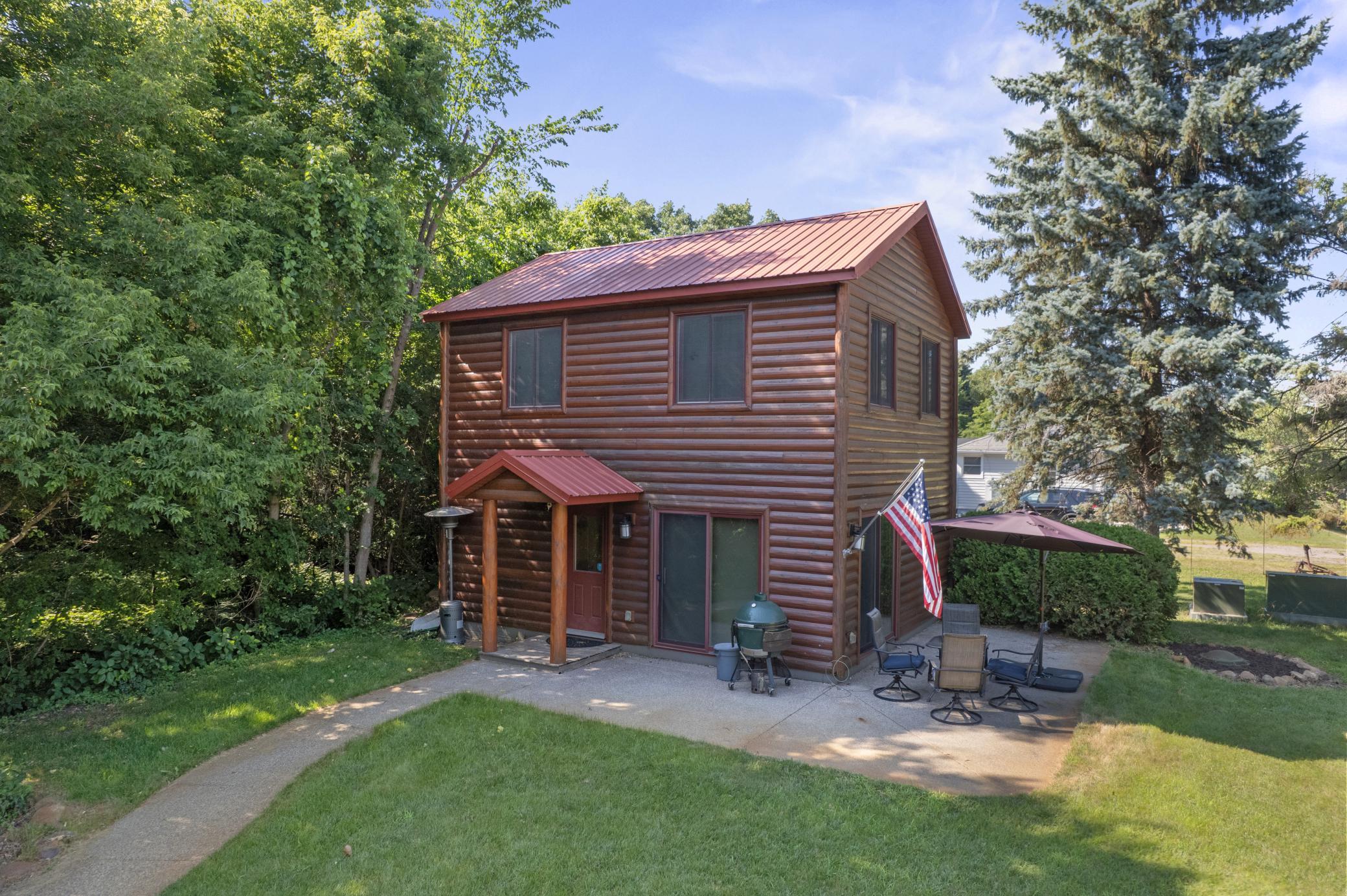 A charming, peaceful retreat for every season and every reason! This immaculately maintained, year-round log-sided home sits on over an acre of premium, level lakeshore, offering breathtaking, panoramic views of Grand Lake. Inside, the home wraps you in warmth with beautiful knotty pine finishes throughout, perfectly balanced by the practical convenience of low-maintenance tile flooring across the main level.The heart of the home is a gorgeous kitchen complete with durable granite countertops, rich hickory cabinets, and a center island with seating for two. Dual patio doors open wide to a fabulous wrap-around patio, making indoor-outdoor entertaining a breeze. The main level also features a convenient 3/4 bath and a laundry room equipped with new appliances. Upstairs, you will discover a massive great room and primary bedroom suite that boasts spectacular elevated lake views and ample room to relax. This flexible space can easily be split into two separate bedrooms depending on your needs.Step outside to explore your private oasis, featuring beautiful perennial gardens, a serene creek view, and a massive storage shed for all your lake toys. Unwind after a long day on the water in your private lakeside sauna, upgraded with a brand-new heating system. Best of all, this secluded paradise offers the perfect blend of privacy and convenience, sitting within easy distance to several local shops and dining favorites. Major bonus Dock is also included and many of the furnishings will also be available.