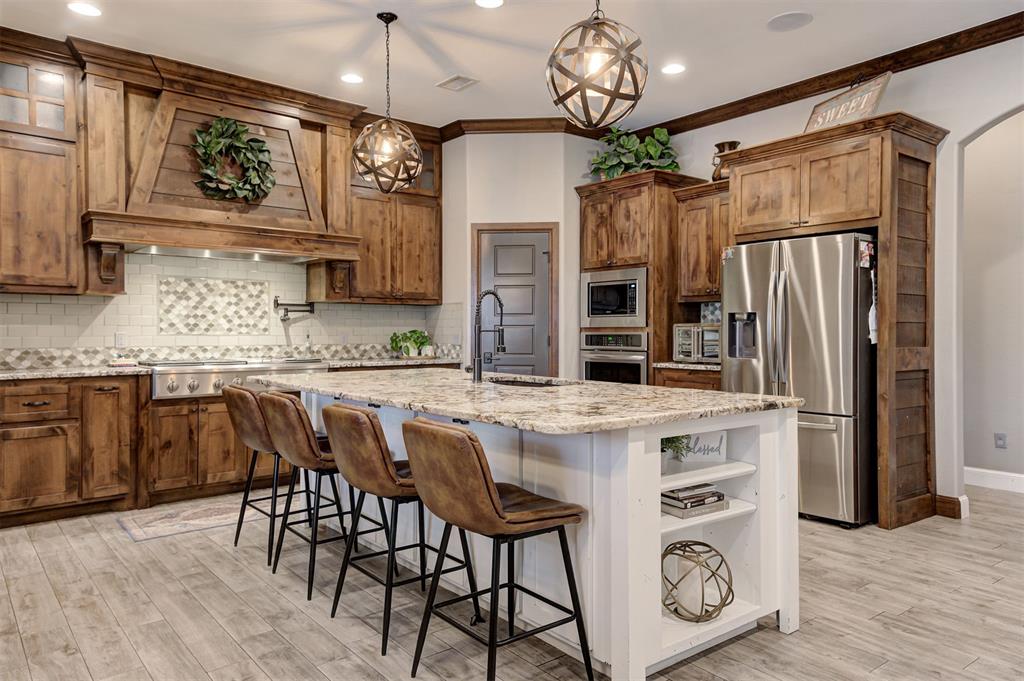 Welcome to 2017 Providence Drive—an exceptional home situated on a spacious corner lot in the highly desirable Hallbrooke community of NE Norman. This move-in ready beauty offers 3,900 square feet of thoughtfully designed living space, featuring 5 bedrooms, 3.5 bathrooms, a dedicated study, media room, and game room. The chef’s kitchen impresses with granite countertops, a massive island, 6-burner gas cooktop with griddle, convection oven, and built-in microwave. Just off the kitchen, you’ll find a private bar with its own ice maker and sink—perfect for hosting. Comfort meets efficiency with a whole-house geothermal HVAC system, built-in surround sound, and a full security system with cameras that will remain with the home. Step outside and enjoy your personal backyard oasis, complete with a sparkling swimming pool and diving board, relaxing hot tub, outdoor fireplace, and a fully equipped outdoor kitchen with built-in grill. Hallbrooke residents enjoy access to top-notch amenities, including a beautiful clubhouse, scenic walking trails, private ponds, and a resort-style community pool with waterfalls and lap lanes. Ideally located near I-35, the University of Oklahoma, shopping, and University Town Center, this home offers the perfect blend of luxury, comfort, and convenience. Don’t miss your chance to make it yours!