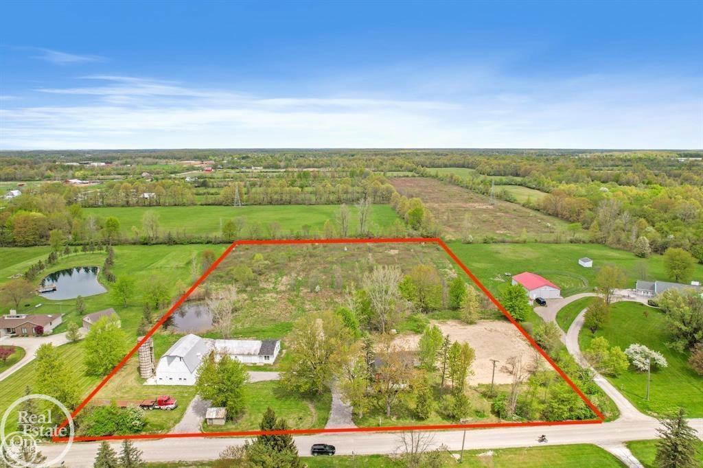 Escape to your own private retreat with 6+acres of serene, wooded beauty-perfect for outdoor living, recreation, and year-round adventure. This beautifully updated split-level home blends farmhouse charm with modern finishes, offering comfort, style, and space for every need. Step into a bright, welcoming foyer with refinished hardwood floors flowing through most of the main level. The brand-new kitchen features soft-close shaker cabinets with 42" uppers and crown molding, granite countertops, stainless steel appliances, and recessed lighting. A flexible room off the kitchen can serve as a formal dining area, home office, or playroom. Convenient first-floor laundry and a fully updated half bath add to the functionality. The spacious primary bedroom offers a large walk-in closet, recessed lighting, ceiling fan, and a stunning new ensuite bath with a dual-sink granite vanity, relaxing clawfoot tub, and tiled shower with surround. The second level features two generous bedrooms, a loft with new carpet, and a newly updated full bath with a dual-sink vanity, granite counter, and subway-tile shower with stone floor. Enjoy the great room's abundant natural light, bay window, and open layout, or step outside to your new cement patio with outdoor fireplace-perfect for summer evenings under the stars. Extra Buildings for Work &Play! A large barn provides ample workshop space plus a finished bonus room for a home office, hobby space, or guest accommodations. Additional outbuildings are ready to store your outdoor gear, vehicles, or recreational toys. Move-in ready and set for your next adventure-welcome home to the best of country living. Other brand-new updates include: roof, roof sheathing, insulation, furnace and A/C, water heater, septic tank and field, updated electrical, updated plumbing, most windows replaced, vinyl siding, front and side entry stairs and decks. New well and large circular drive with new limestone.