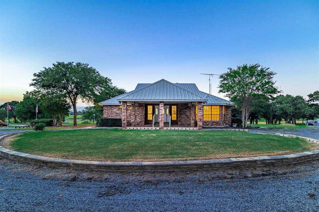 A beautiful private ranch style home, with a nice view of Fort Worth, embracing the natural beauty in God's country on187 acres of land. Enjoy horseback riding, drive ATV’s or dirt bikes, and great fishing in the stock ponds. Income producing, with an additional small 3 bedroom home and one bedroom apartment, as well as a huge barn, two towers, a grass lease for hay, a huge barn, shop and a private road. Only 15 minutes from downtown Fort Worth! Do not enter any gates or drive onto the property without the agent! It is currently occupied.